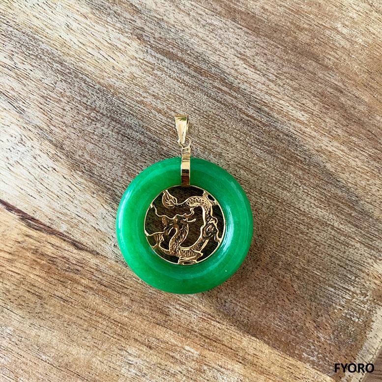 The 'Lantau Jade Dragon Donut Pendant' is an eternal tribute to Lantau Island. Rustic, natural, created, and perfect.

The Jade circumference directs light to the Gold Dragon Carving, shining light onto the intricacies of design. Centrally focused,