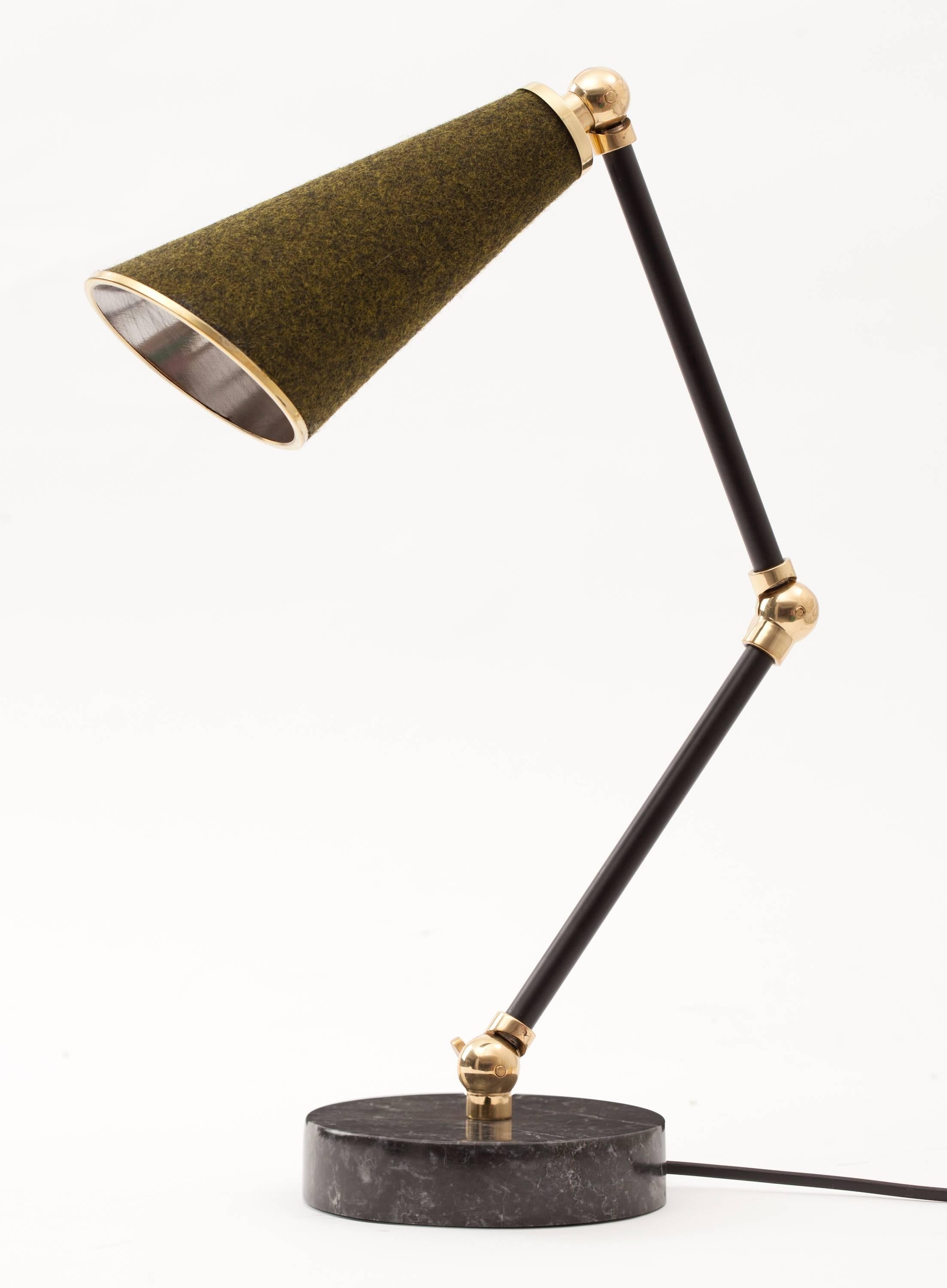 The uniquely designed Lanterna lamp by NY-based designer Merve Kahraman is a new age robot desk lamp or table lamp with a heart.

Unique textured materials such as felt, cork and cowhide are combined with white and black coloured marbles and shiny
