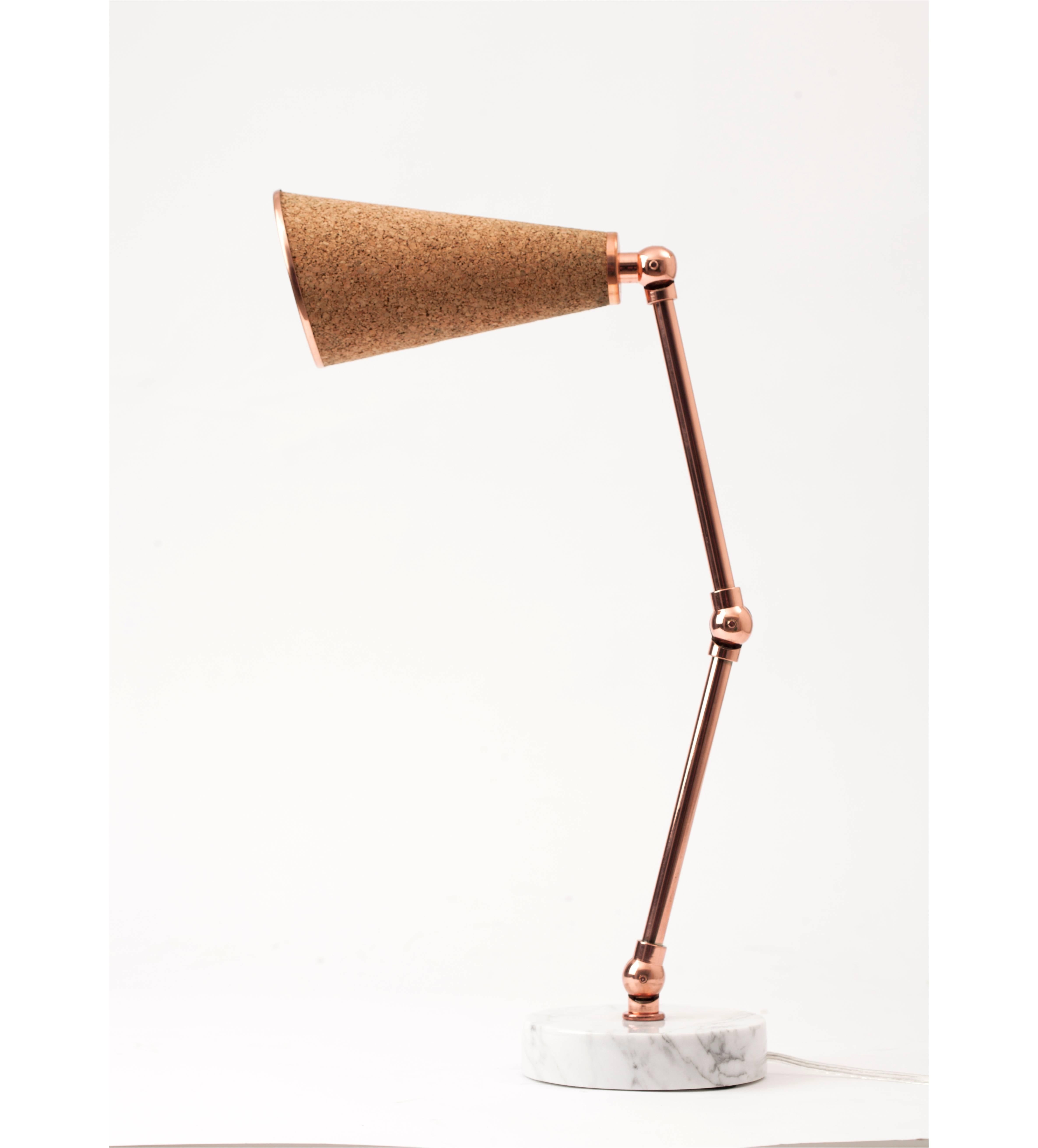 The uniquely designed Lanterna Lamp by NY-based designer Merve Kahraman is a new age robot desk lamp or table lamp with a heart.

Unique textured materials such as felt, cork and cowhide are combined with white and black colored marbles and shiny