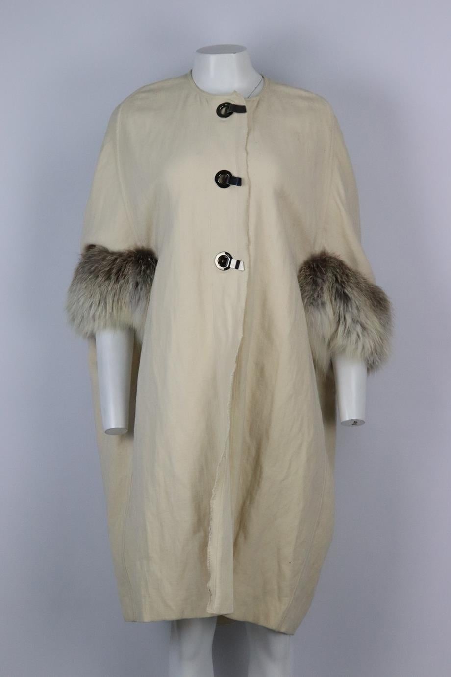 Lanvin 2007 fox fur trimmed wool coat. Cream. Short sleeve, crewneck. Hook and eye fastening at front. 62% Wool, 33% cotton, 5% metal; trim: 100% fox. Size: FR 36 (UK 8, US 4, IT 40). Shoulder to shoulder: 16 in. Bust: 58 in. Waist: 58 in. Hips: 58