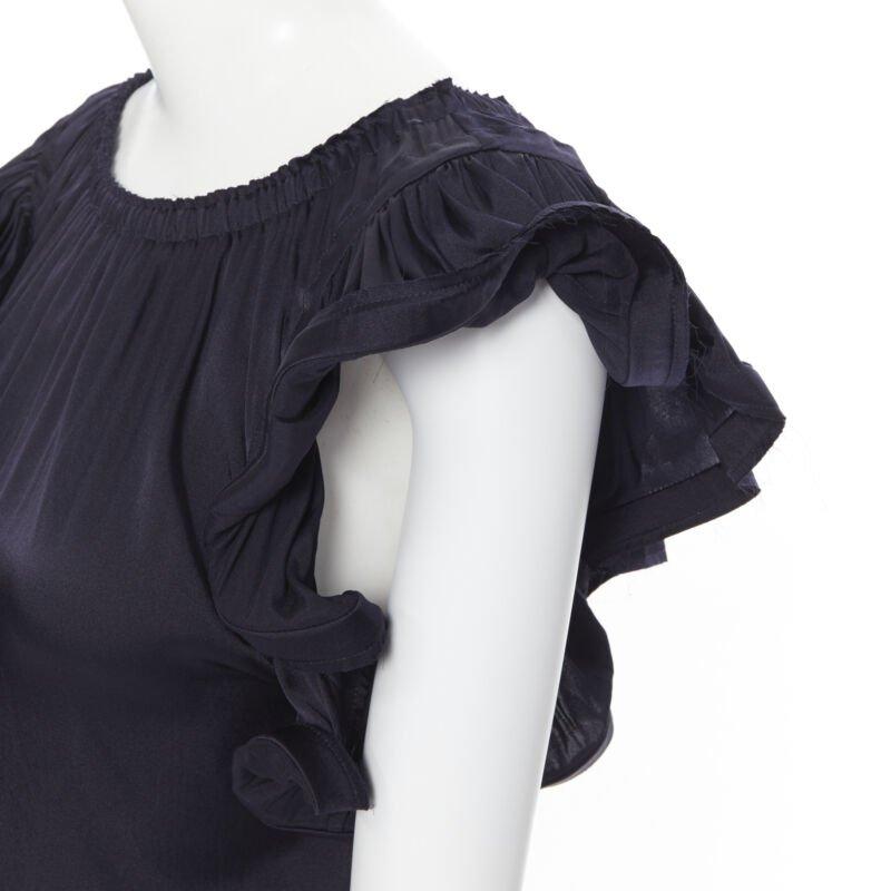 LANVIN ALBER ELBAZ 2008 stretch silk elasticated neck ruffle sleeve top FR34 XS
Reference: SNKO/A00090
Brand: Lanvin
Designer: Alber Elbaz
Model: Ruffle top
Collection: Spring Summer 2008
Material: Silk
Color: Navy
Pattern: Solid
Extra Details:
