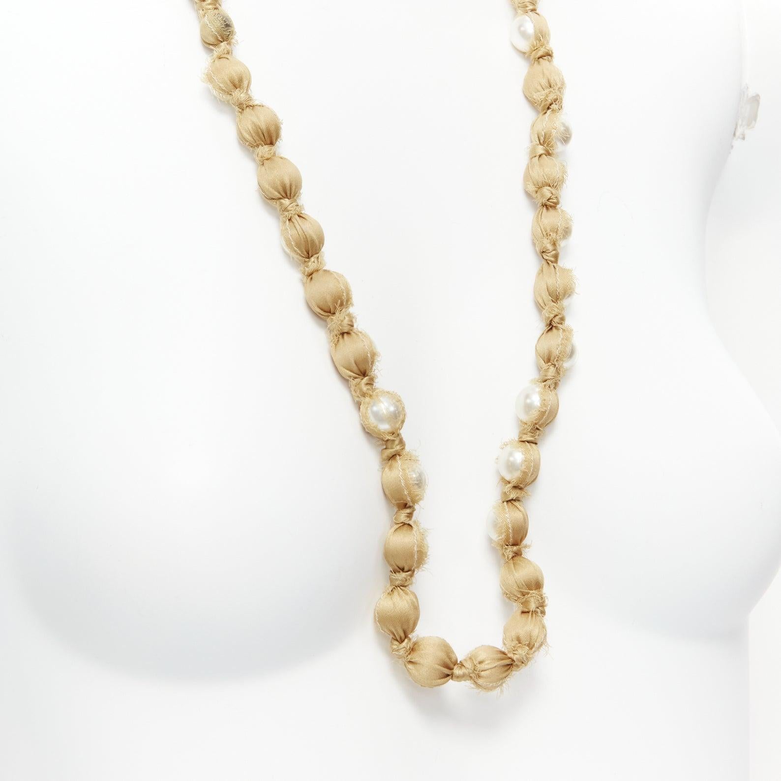LANVIN ALBER ELBAZ gold silk ribbon cream pearl wrap long necklace
Reference: SNKO/A00341
Brand: Lanvin
Designer: Alber Elbaz
Material: Silk, Faux Pearl
Color: Pearl, Gold
Pattern: Solid
Closure: Self Tie

CONDITION:
Condition: Excellent, this item