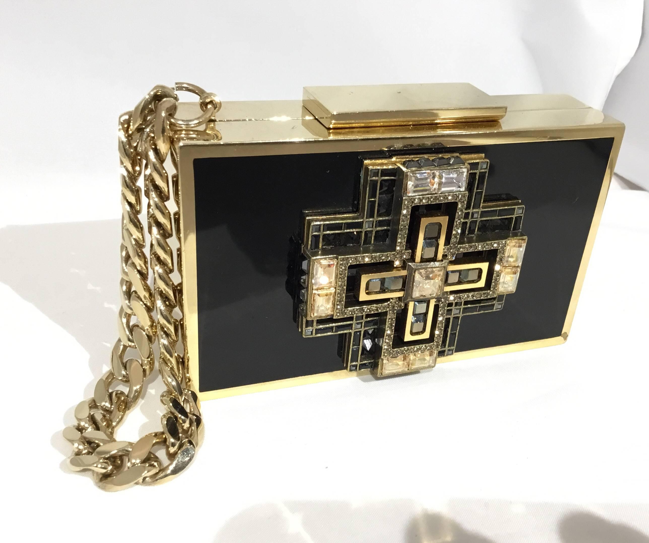 Lanvin evening clutch with crystal art deco design at the front, gold-tone Cuban link wrist handle. Clutch is fully lined in a brown velvet fabric. Light wears to the metal throughout from normal handling. Overall excellent condition.

Measurements: