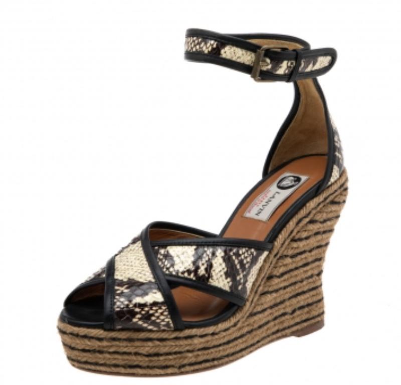 These unique sandals from Lanvin will lend a stylish and elegant edge to your feet. Crafted in Spain, they are made from python-embossed leather and come in a lovely shade of beige and brown. They come with criss-cross front straps, buckle closures,