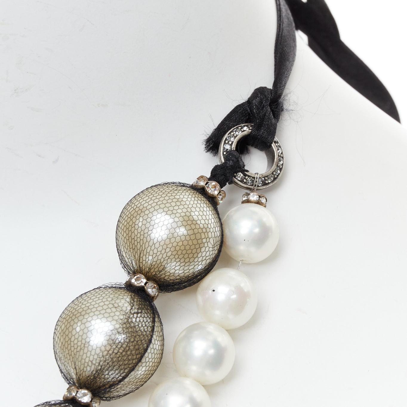 LANVIN black double strand wrapped faux pearl ribbon tie statement necklace
Reference: TGAS/E00874
Brand: Lanvin
Designer: Alber Elbaz
Material: Faux Pearl, Fabric
Color: Black, Pearl
Pattern: Solid
Closure: Self Tie
Extra Details: Logo coin
