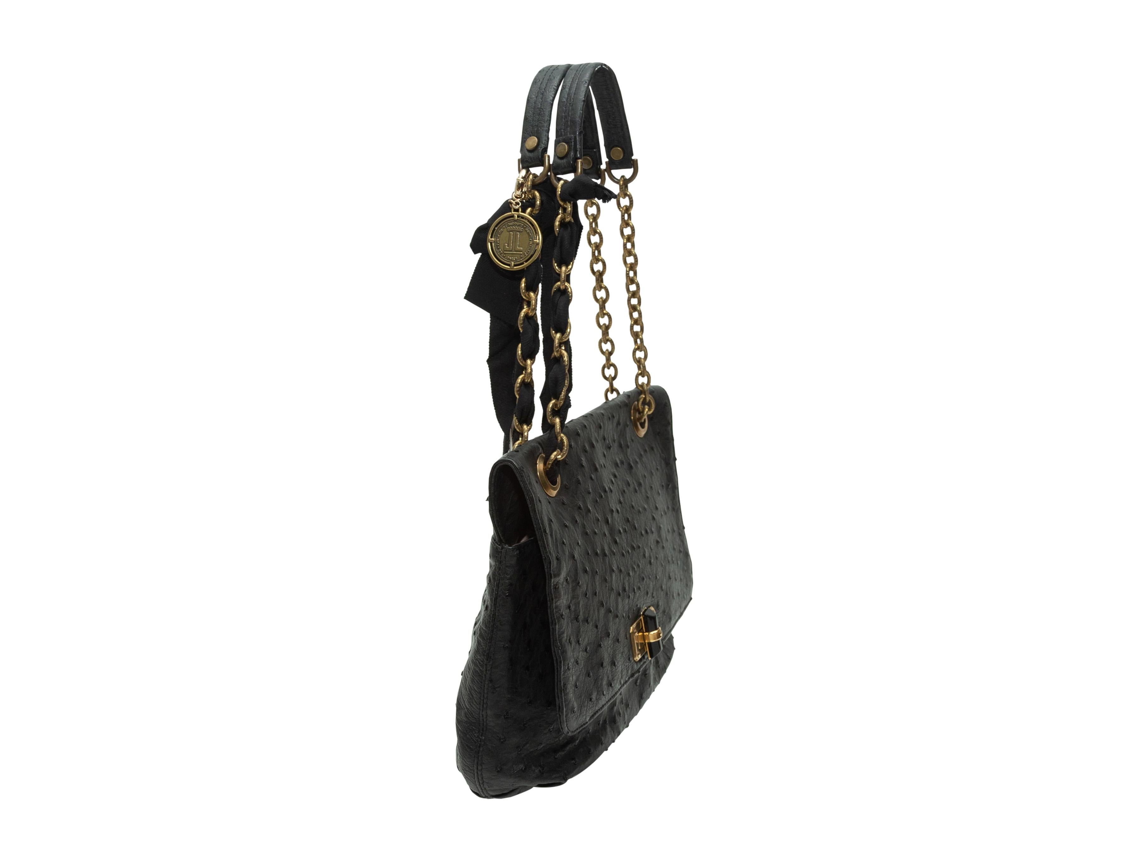 Product Details: Black ostrich leather shoulder bag by Lanvin. Gold-tone hardware. Grosgrain accent at chain-link and leather strap. Interior zip pocket. Turn-lock closure at front flap. 12