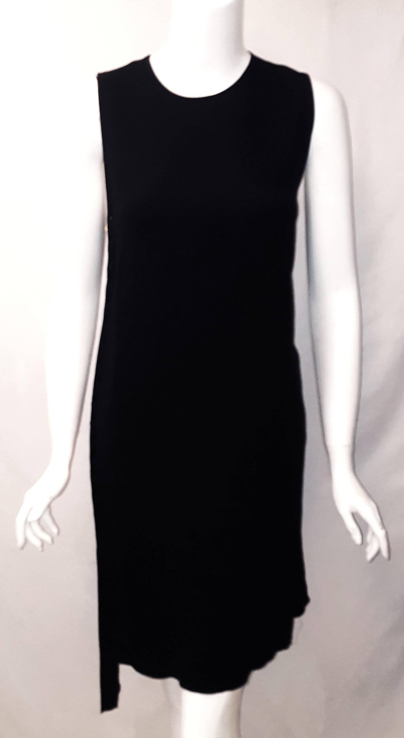Lanvin's summer 2015 black sleeveless sheath dress has a round collar and a hidden back zipper for closure.  The gold tone 1