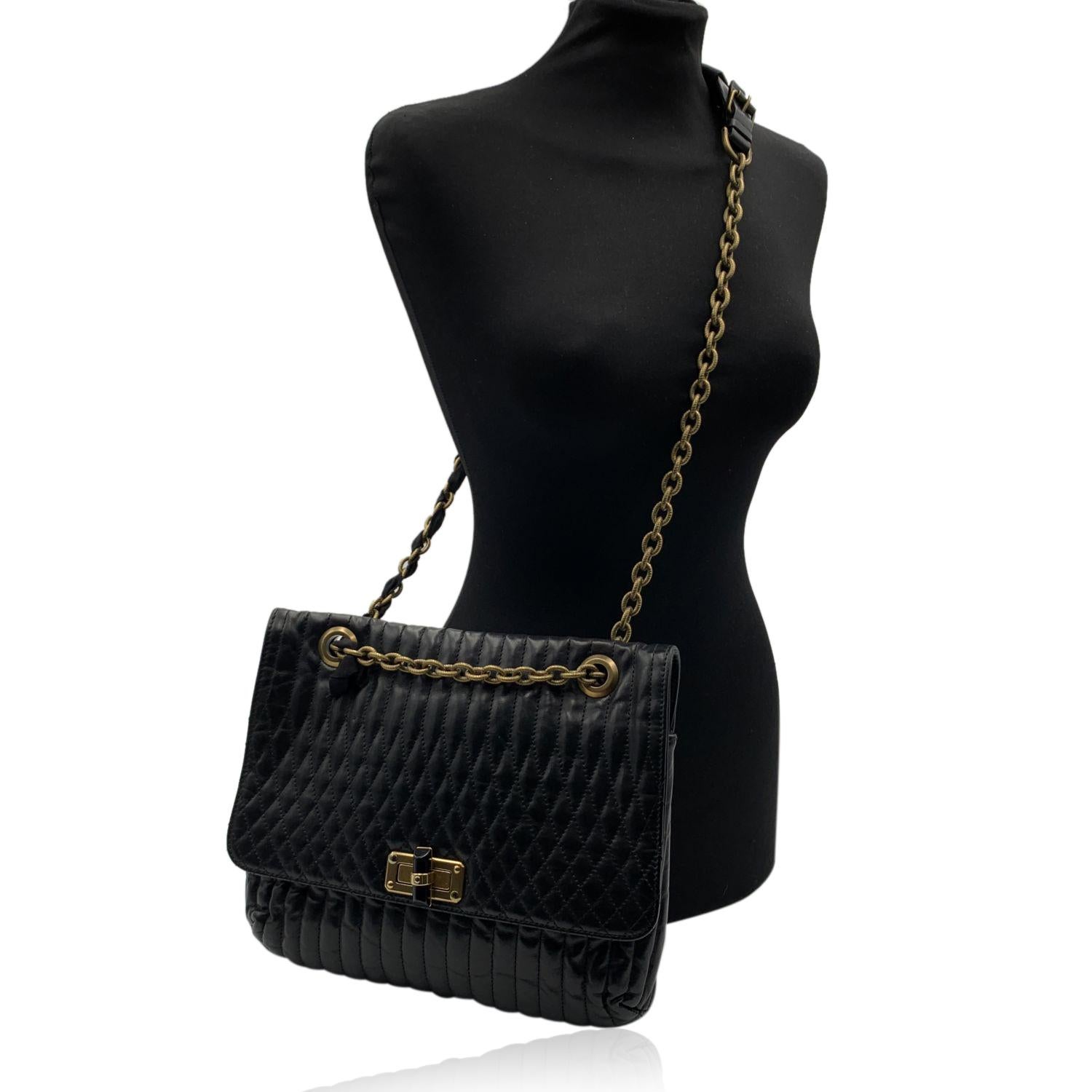 Lanvin 'Happy' shoulder bag in soft quilted leather. Brass chain handles with black leather top and interwoven gros-grain ribbon. Removable Lanvin charm. Flap with front twist closure open to a black logo fabric lining with a zipped pocket inside.
