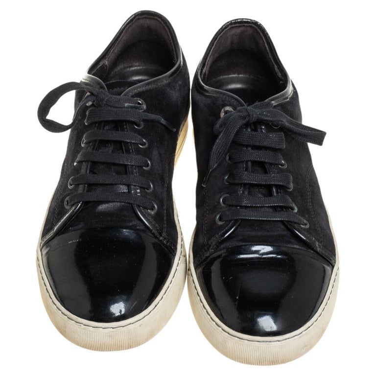 Crafted from a combination of suede and patent leather, these sneakers feature simple tie-ups and come equipped with comfortable leather-lined insoles and white rubber soles. These sneakers by Lanvin are sure to charm all.

