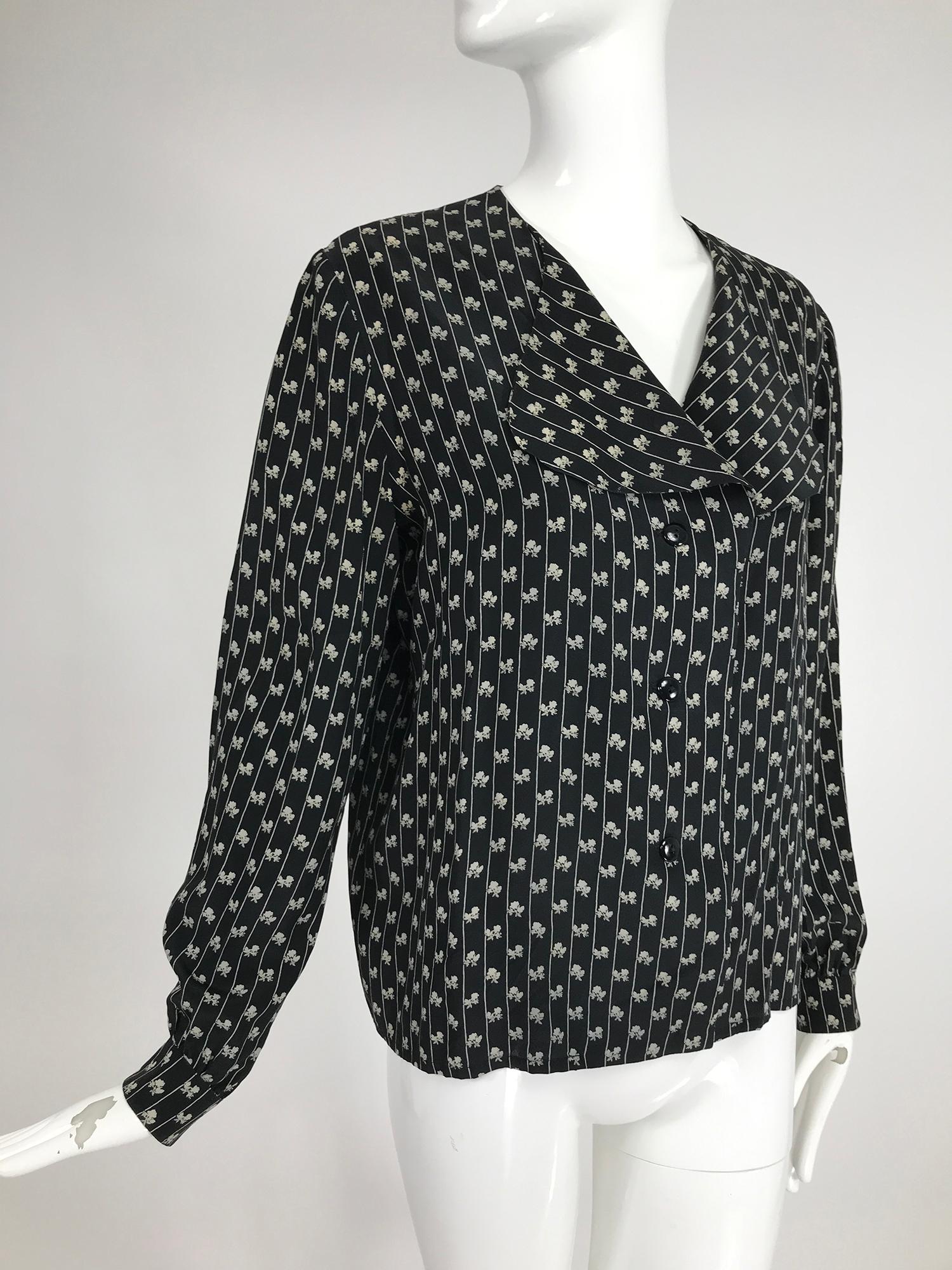 Lanvin black & white silk mini floral print blouse from the 1970s size 44. Button front blouse has a deep rounded wing collar, long sleeves with button cuffs and a V neckline. Great to wear belted over tights or skirts or tucked into jeans. Marked