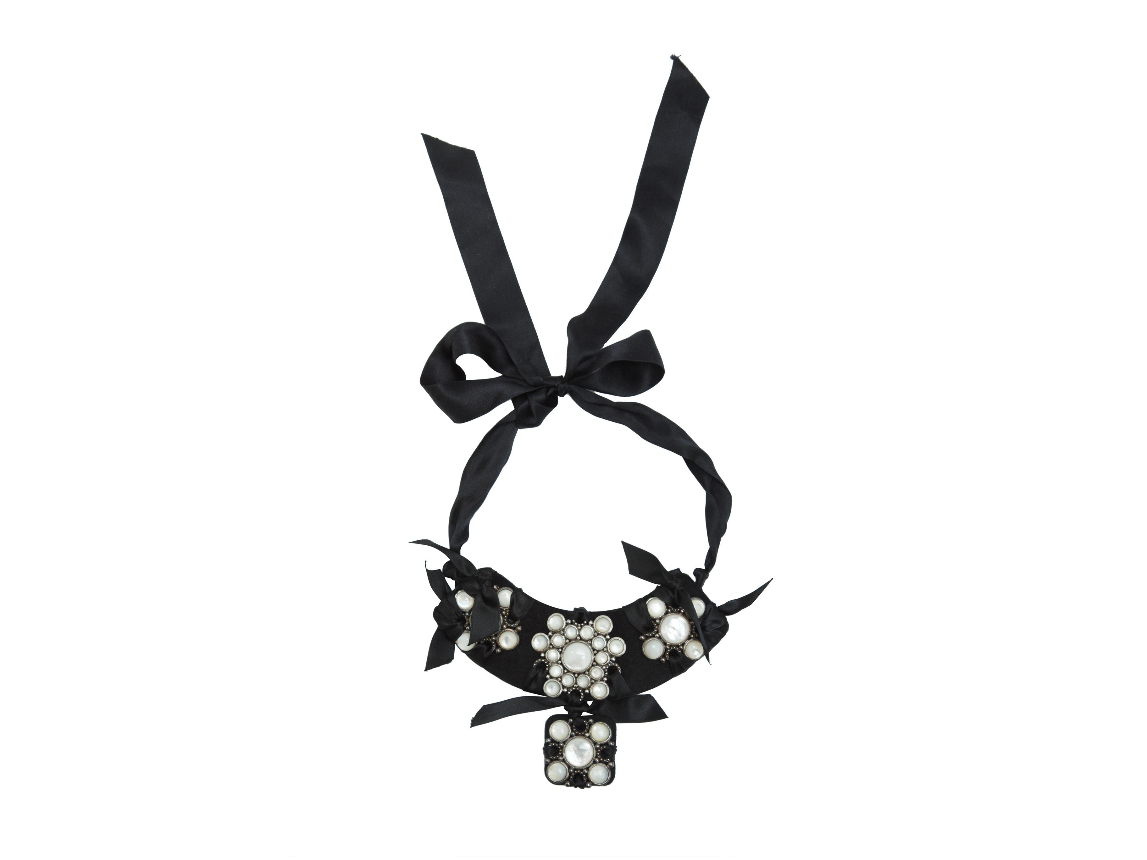 Product details: Black and white satin statement necklace by Lanvin. Stone embellishments throughout. Ribbon tie closure at back. 2