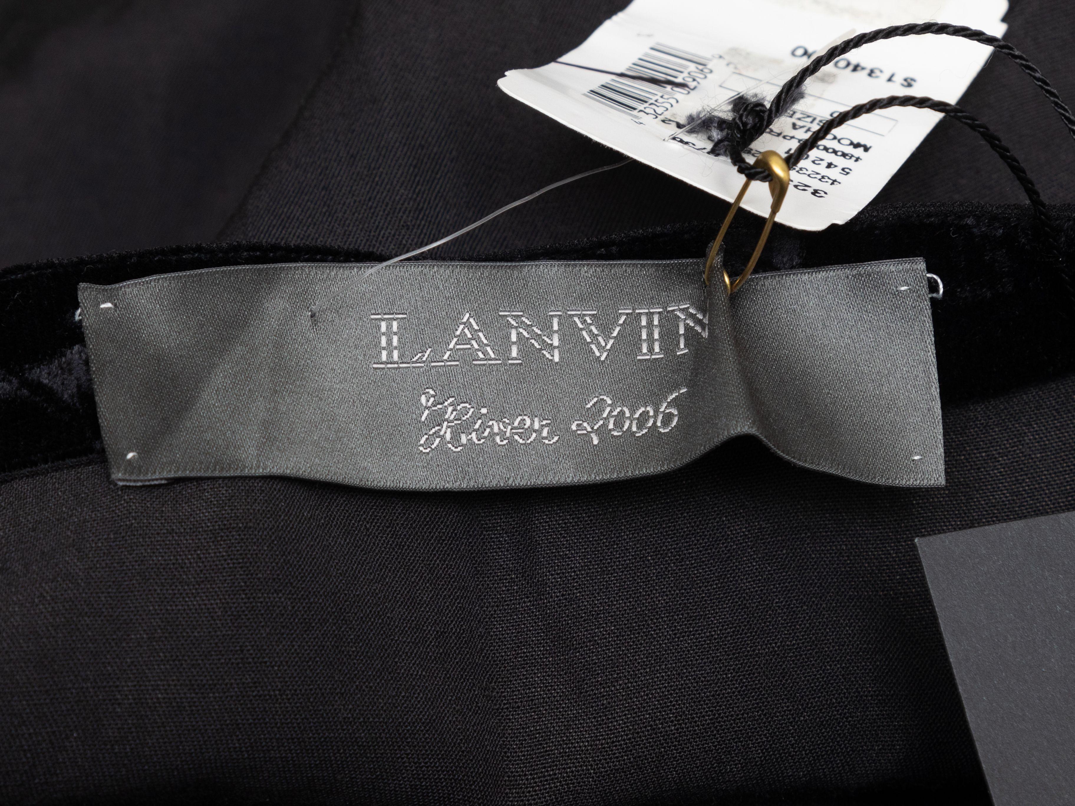 Product Details: Black wool and velvet knee-length skirt by Lanvin. From the Winter 2006 Collection. Side zip closure. Designer size 40. 29