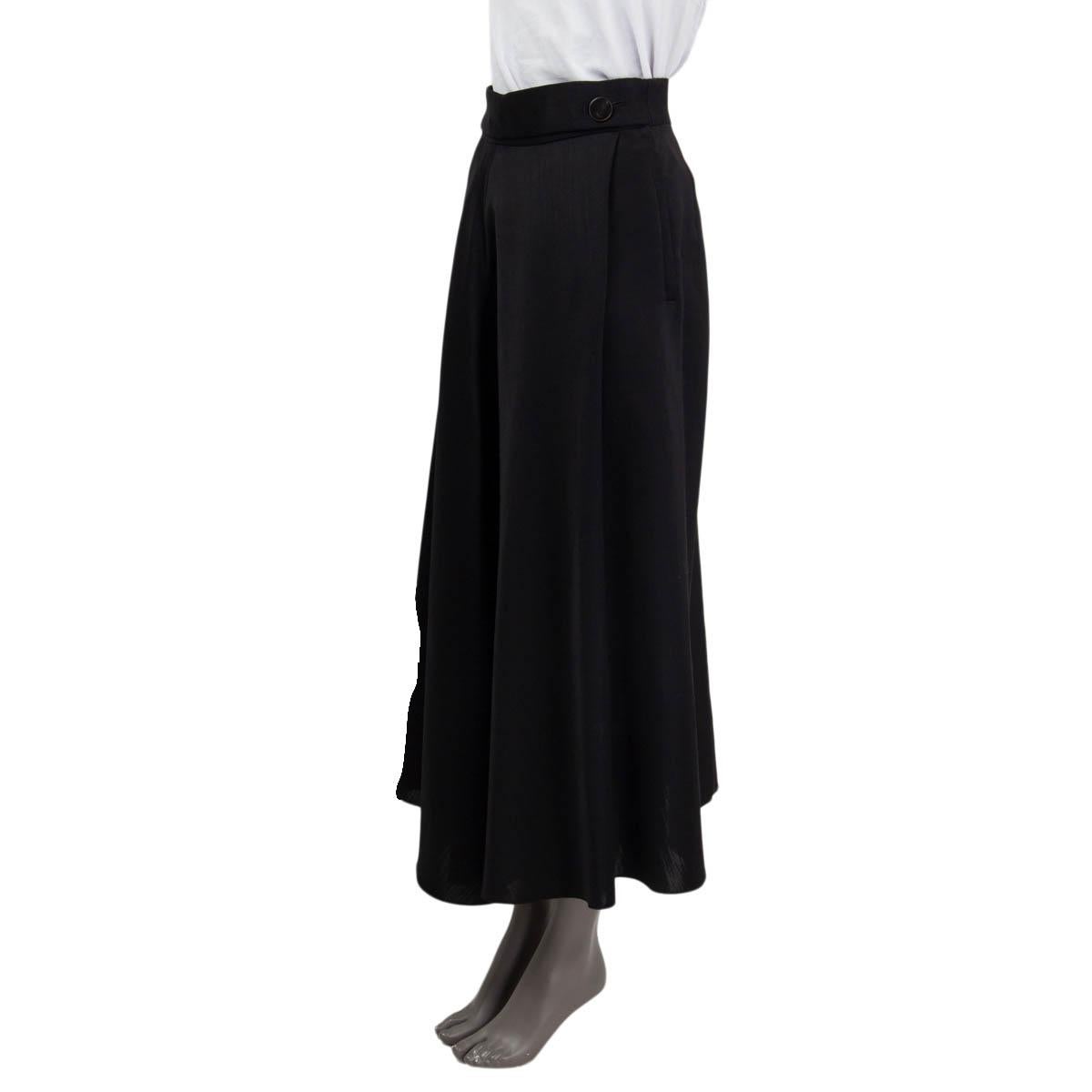 100% authentic Lanvin full length skirt in black wool (80%) and silk (20%). The design features two front pleats with hidden side pockets. Skirt closes with a zipper on the side and two buffalo horn and brass buttons on the each side. Unlined. Has