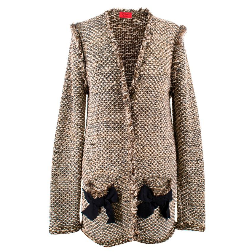 Lanvin Boucle-Tweed Jacket

- Collarless
- V-neckline
- Frayed hemlines
- 2 front pockets with grosgrain bow detail
- Metallic threads running through
- 4 antique-gold concealed pop buttons to fasten at the front
- Long sleeves

Please note, these