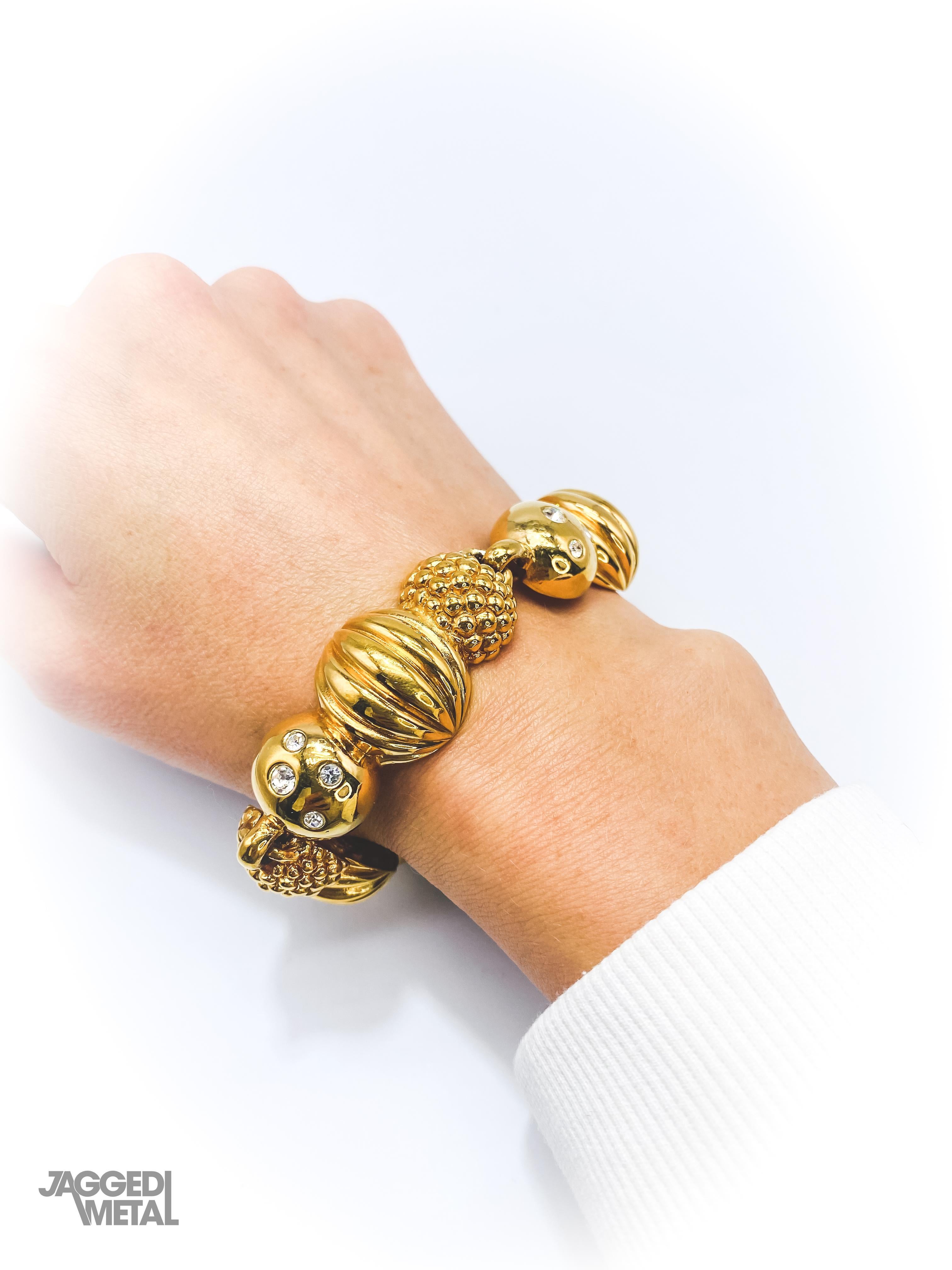 Lanvin 1980s Vintage Bracelet

An amazing statement bracelet from the House of Lanvin, with classic 80s glam styling. Made in France in the mid to late 80s, cast from textured gold plated metal and set with tiny crystals. Team with your favourite