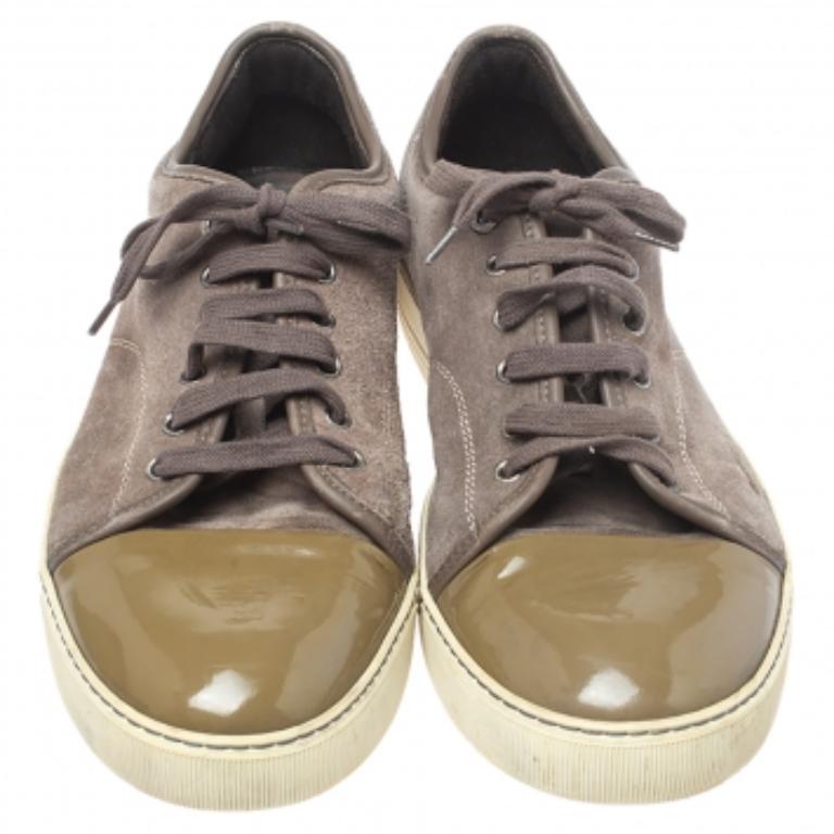 Amp up your casual looks by wearing these Lanvin sneakers that crafted in Italy. Made from patent leather and suede in brown and green hues, they come in a low top silhouette, round toes, and laces on the vamps. Wear them with cropped denims and