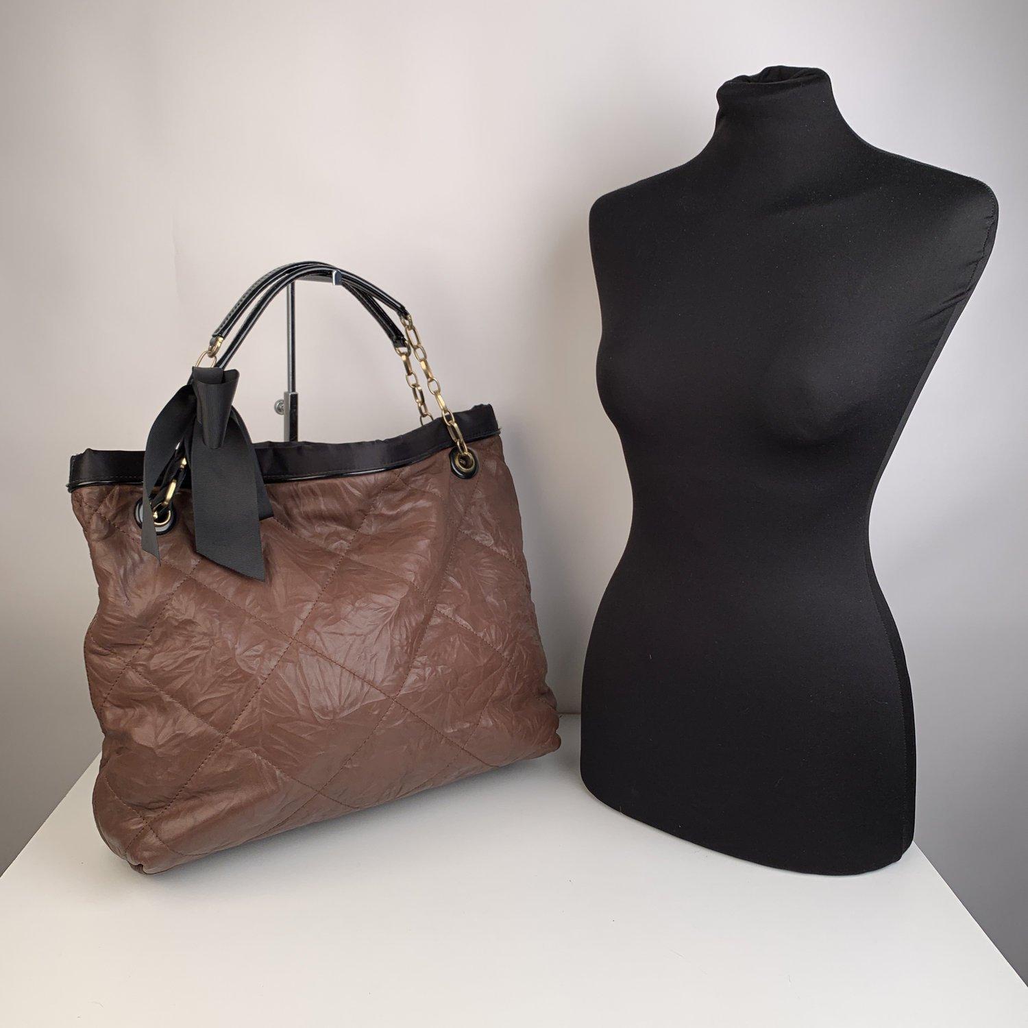 Lanvin large 'Amalia Tote' in soft brown quilted leather. Brass chain handles with black patent leather top and interwoven gros grain ribbon. The top of the bag is trimmed with black satin trim and a patent leather piping. Magnetic snap open to a