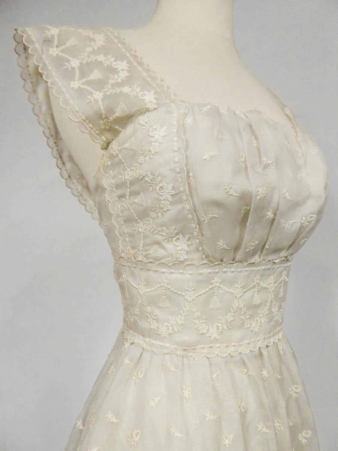 Circa 1957
France

Lanvin Castillo Haute couture ball gown (attributed to) in embroidered cream gazar from the late 1950s. High-waisted dress with square low-cut neckline underlined with gathers and a large matching waistband. Large straps covering