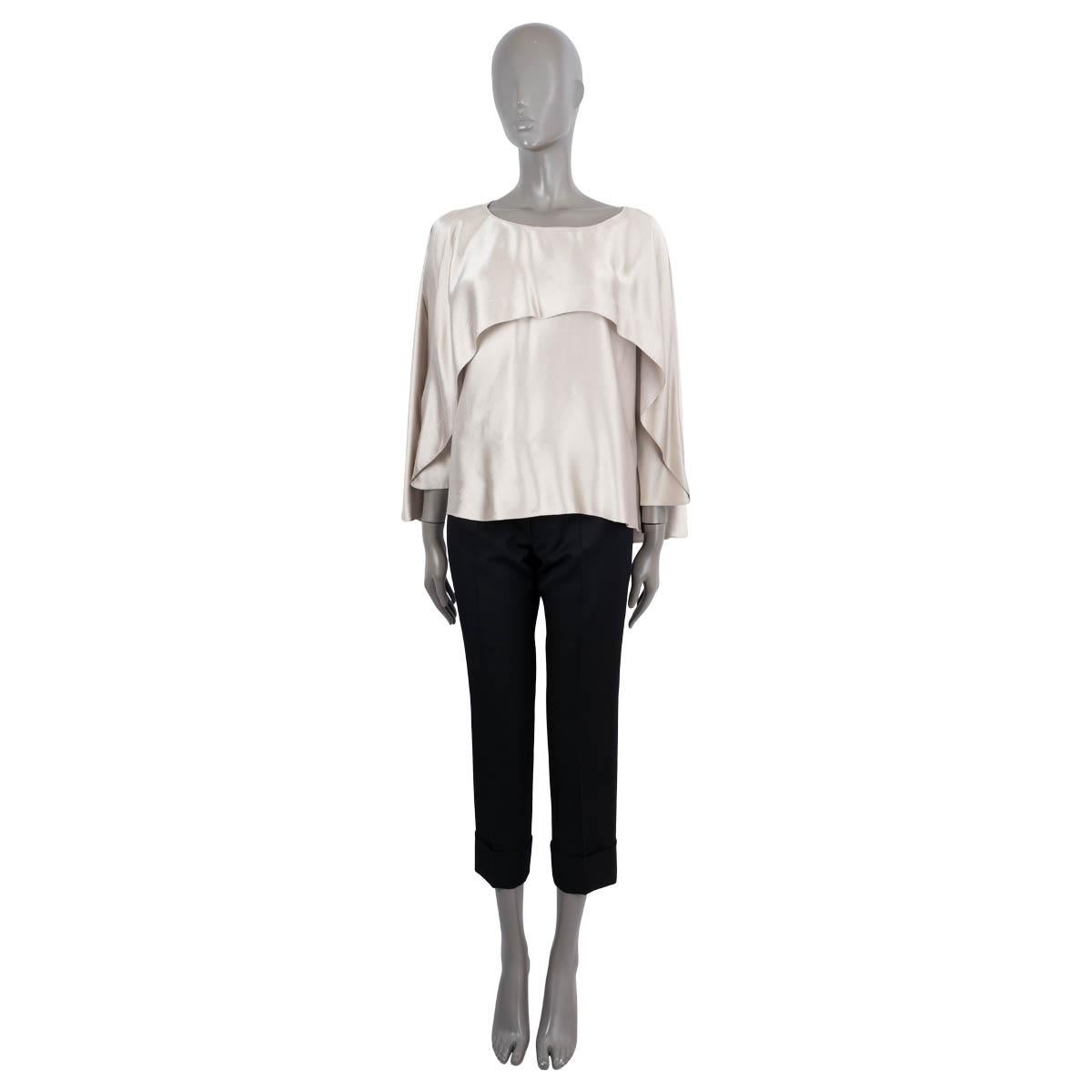100% authentic Lanvin oversized satin blouse in champagne viscose (52%) and acetate (48%). Features an overlay, 3/4 cape sleeves and a round neck. Unlined. Has been worn and is in excellent condition.

2014 Fall/Winter

Measurements
Tag