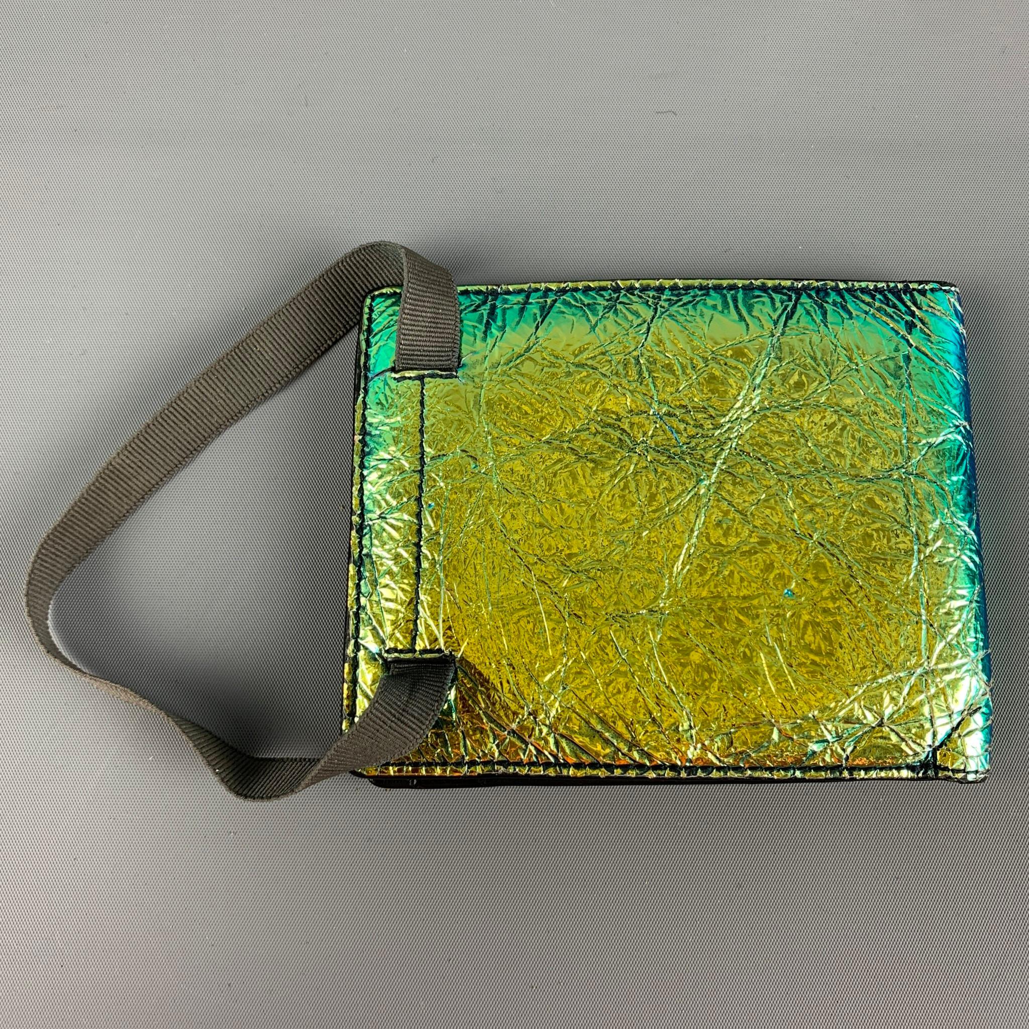 LANVIN wallet comes in a green & blue iridescent wrinkled patent leather featuring a elastic strap and inner slots. Includes box. 

Good Pre-Owned Condition. Light wear. As-is.

Measurements:

Length: 4.5 in.
Height: 3.6 in.