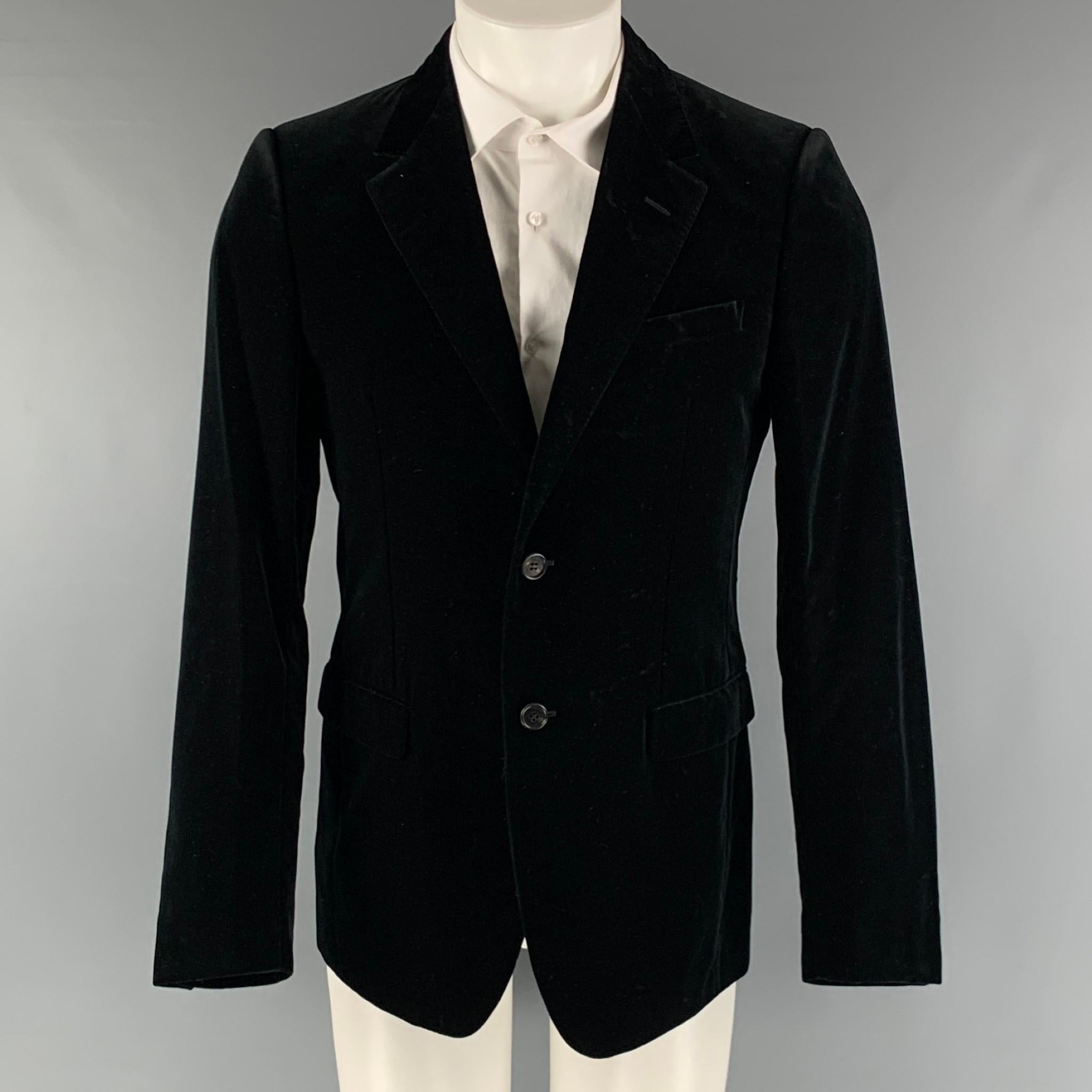 LANVIN sport coat comes in a black velvet cotton woven material with a full liner featuring a notch lapel, flap pockets, single back vent, and two button closure. Made in Italy.

Very Good Pre-Owned Condition. Minor Signs of wear.
Marked: