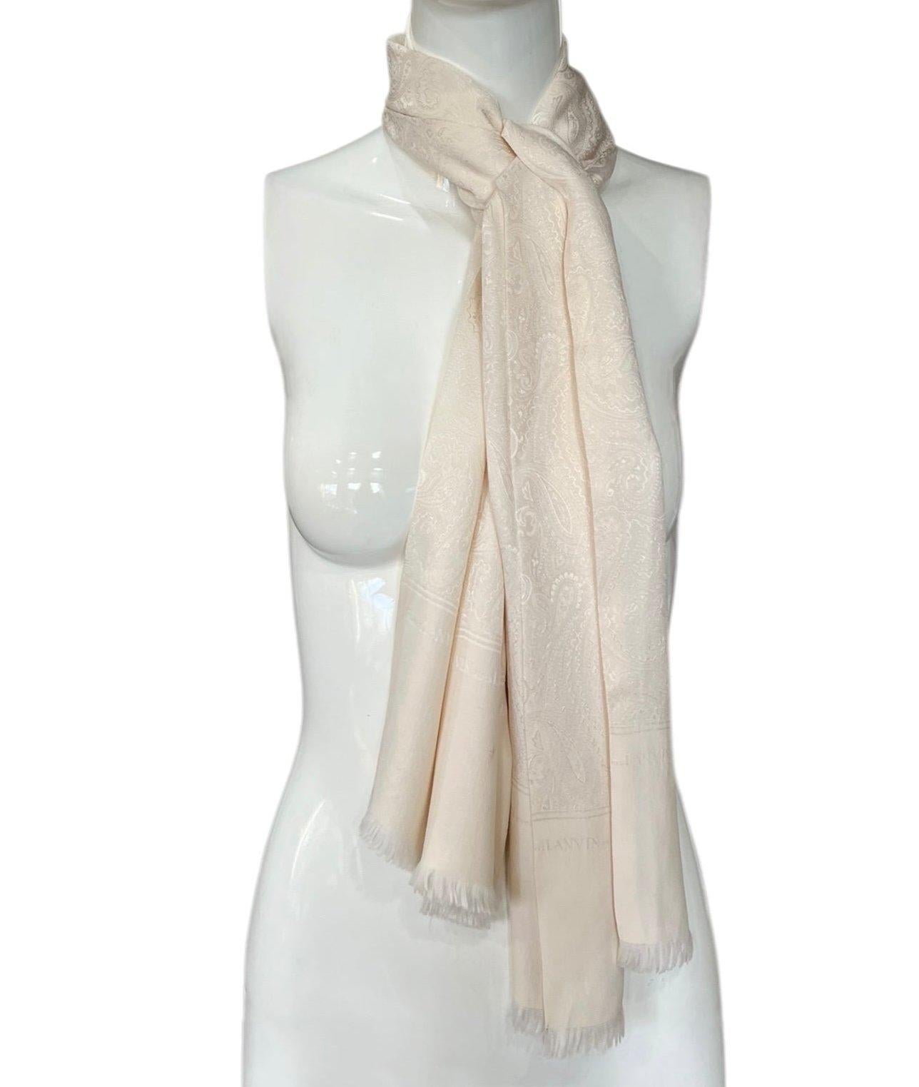 Luxurious cream silk Lanvin scarf. Delicate silk with softly fringed edges along the short sides. Paisley jacquard embroidery. Can be worn infinite ways! Great vintage condition condition with one mark to note shown in the 5th photo.

Additional
