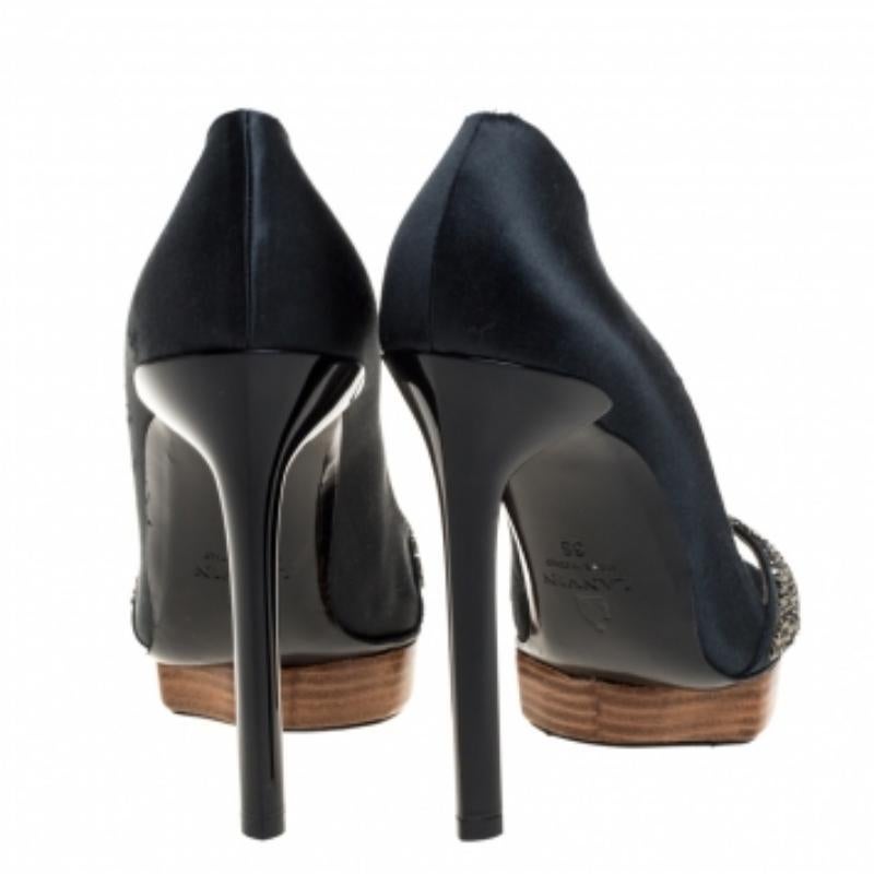 These pumps from Lanvin are crafted from leather and feature a peep-toe silhouette with a crystal-embellished strap. Brilliantly designed, they are equipped with leather-lined insoles, 12.5 cm heels, and platforms for an elevated walk.