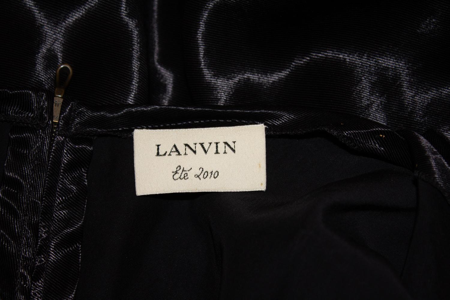 A chic  cocktail dress by Lanvin, Ete ( Summer) 2010 collection.  The dress has a crossover front and v neckline. It has a central back zip  and is unlined. 
Size 38 , Made in France Measurement Bust 38 '', length 42''