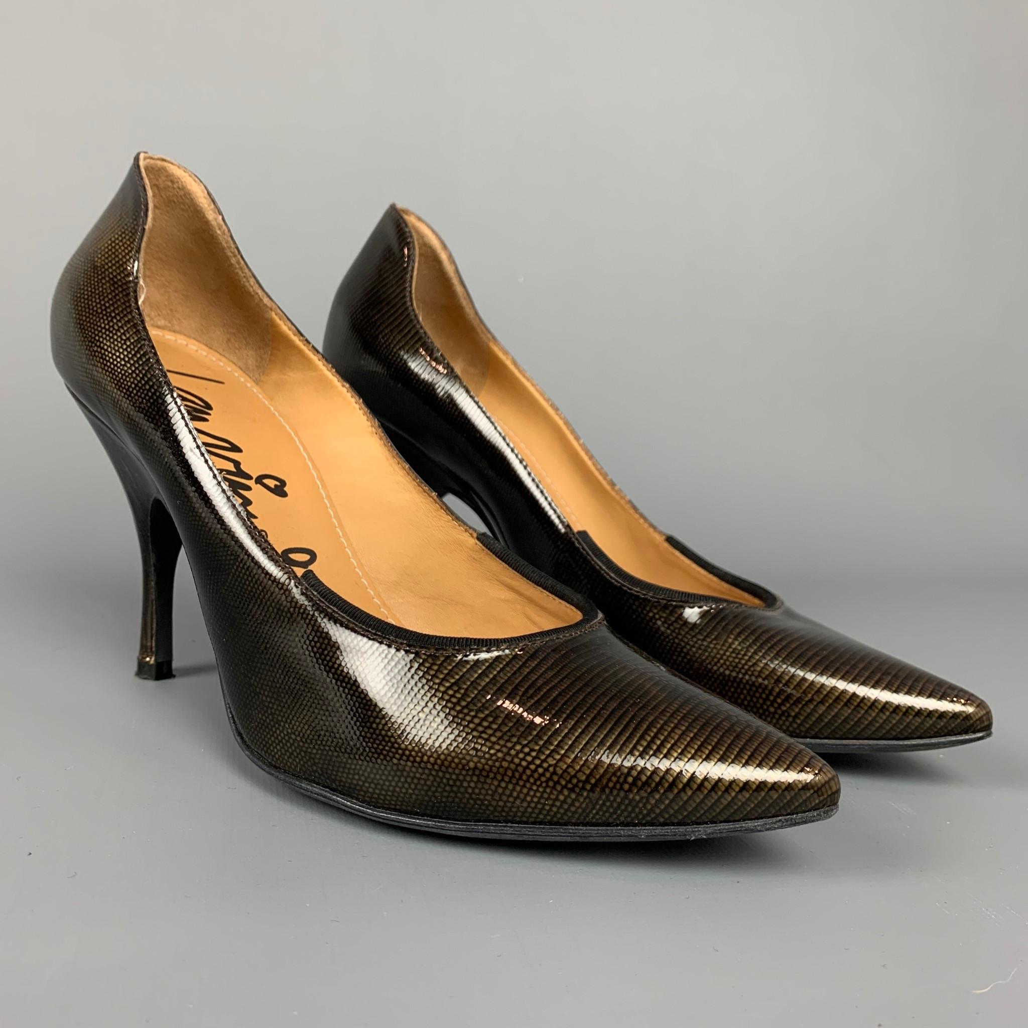 LANVIN for H&M pumps comes in a bronze textured patent leather with a black ribbon trim featuring a pointed toe and a stacked heel. Made in Italy.

Very Good Pre-Owned Condition.
Marked: 38

Measurements:

Heel: 4 in.