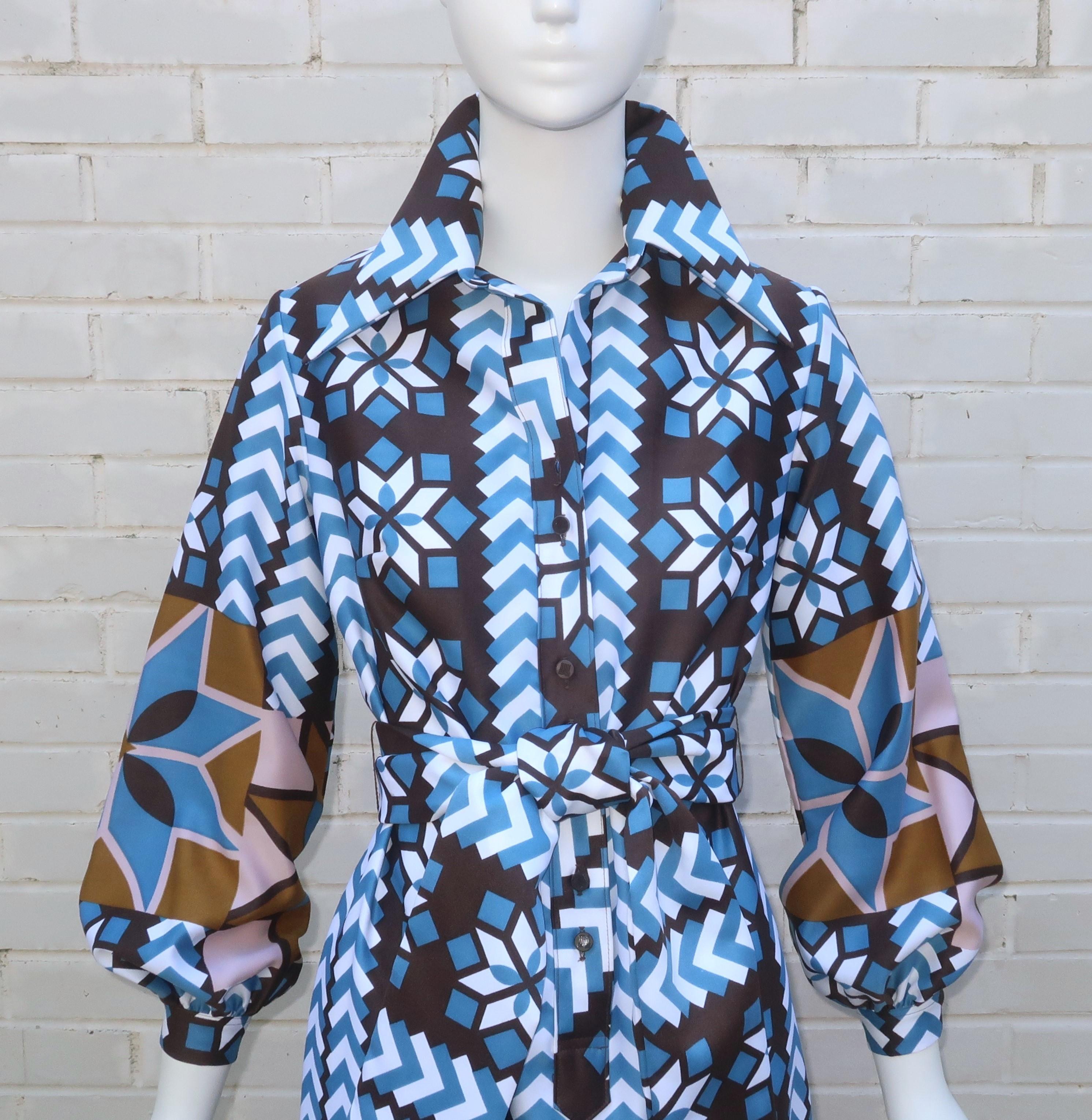 1970’s Lanvin shirt dress in a maxi length with period perfect details including large pointy collar and full sleeves.  The geometric print combines stripes, arrowhead shapes and multi point stars in shades of brown, blue, pink and white.  It has