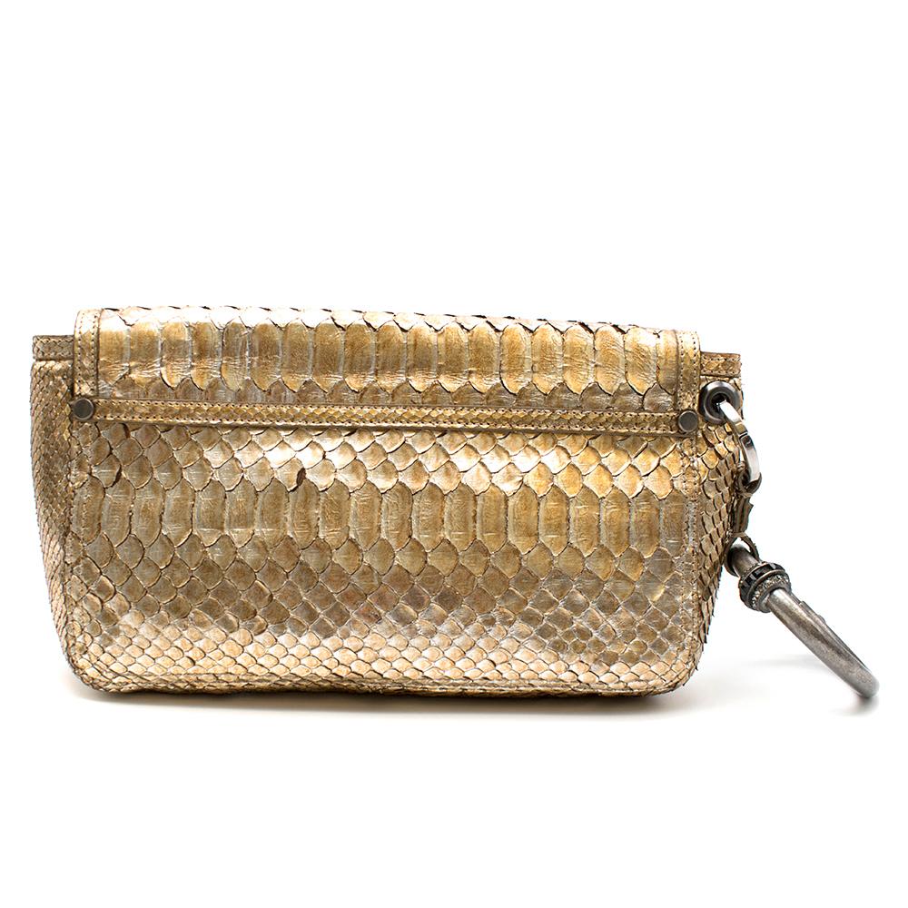 Lanvin gold rectangular wristlet clutch is constructed of metallic python leather featuring front turnlock closure, oversized ring handle detailed with rhinestone and an inside zipper pocket and three smaller flat pockets. 

Please note, these items