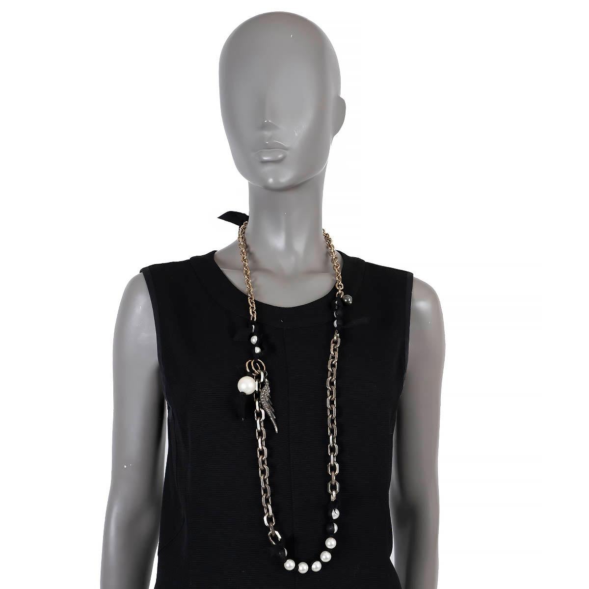 100% authentic Lanvin necklace in gold-tone and antique silver chains and black grosgrain ribbon with faux pearls. Features a crystal encrusted wing. Has been worn and is in excellent condition. 

Measurements
Length	108cm
