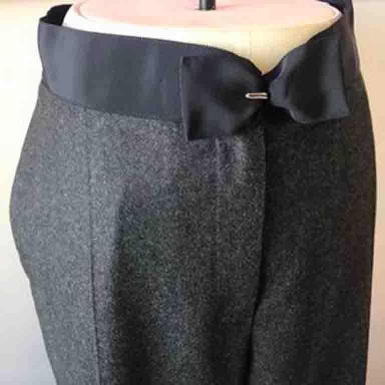 Classic wool / cashmere pants in gray with wide leg design by Lanvin. Perfect for the workplace. Waistband has black ribbon bow and hook eye closure. New without tags.  Side slit pockets.  Black grosgrain ribbon / bow at waist.
Tags says Lanvin 2005