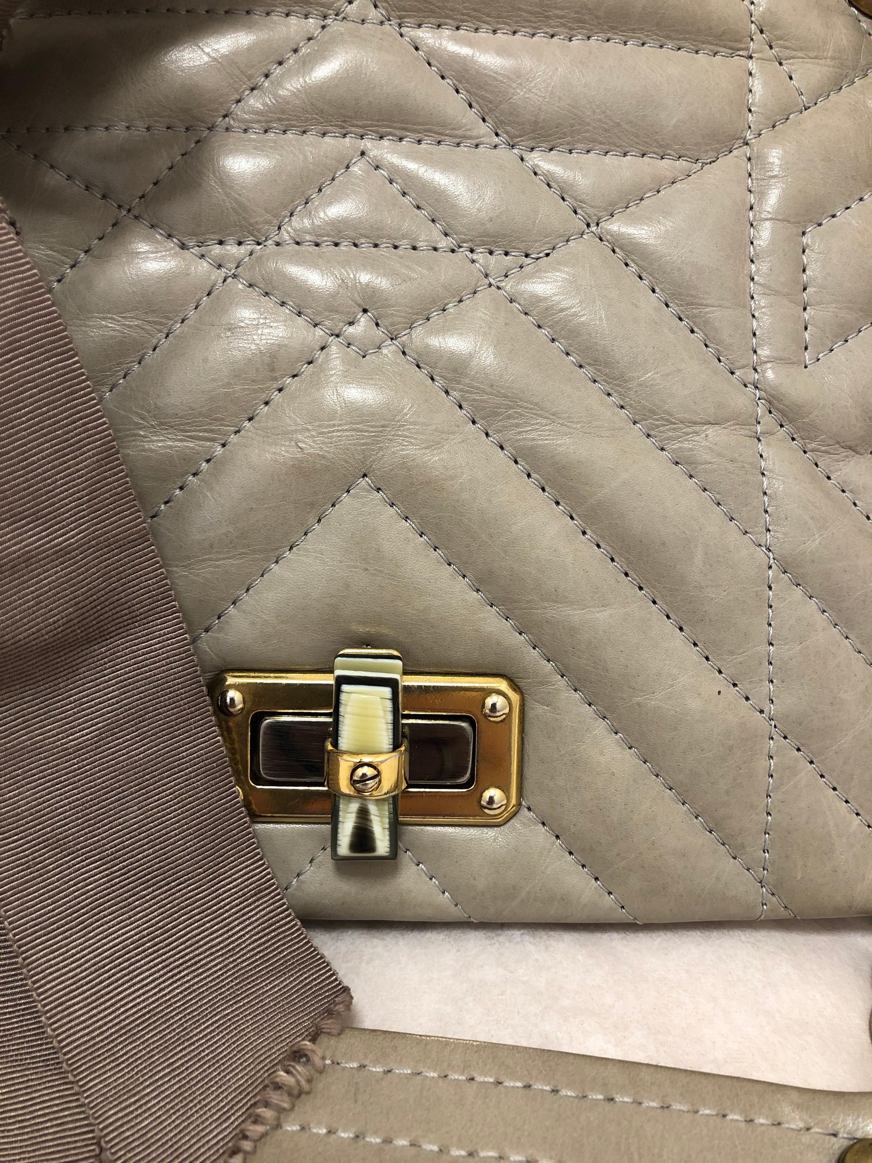 This Lanvin bag is a great contemporary every day bag, crafted from a buttery sof lambskin chevron quilted leather. The Happy bag features a turn-lock closure on the front flap, and a spacious fabric lined interior, with a zipped leather pocket on