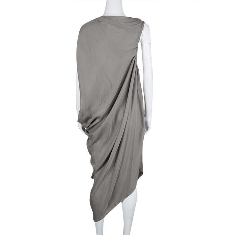 Create a comfortably chic and distinct party look with this stunning Lanvin dress. Constructed in the classic hues of grey, this dress features drawstring gathered tie detail at one of the sleeves along with a draped design along one side and