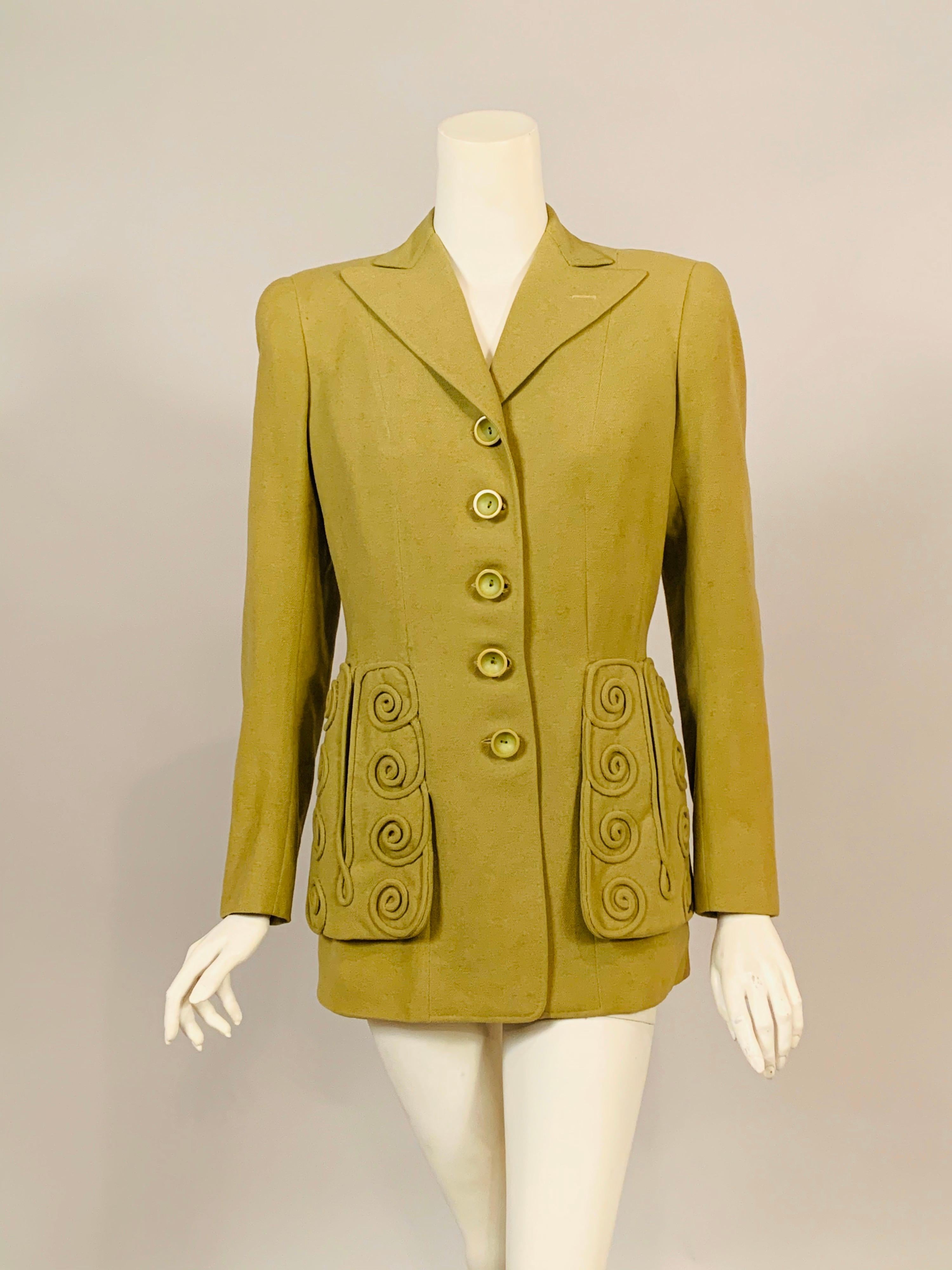 This is a wonderful example of the designs of Jeanne Lanvin, created in May, 1944 during World War II when many French Couture Houses had closed their doors. A Spring green wool jacket, from her Sportswear line, has five buttons at the center front,