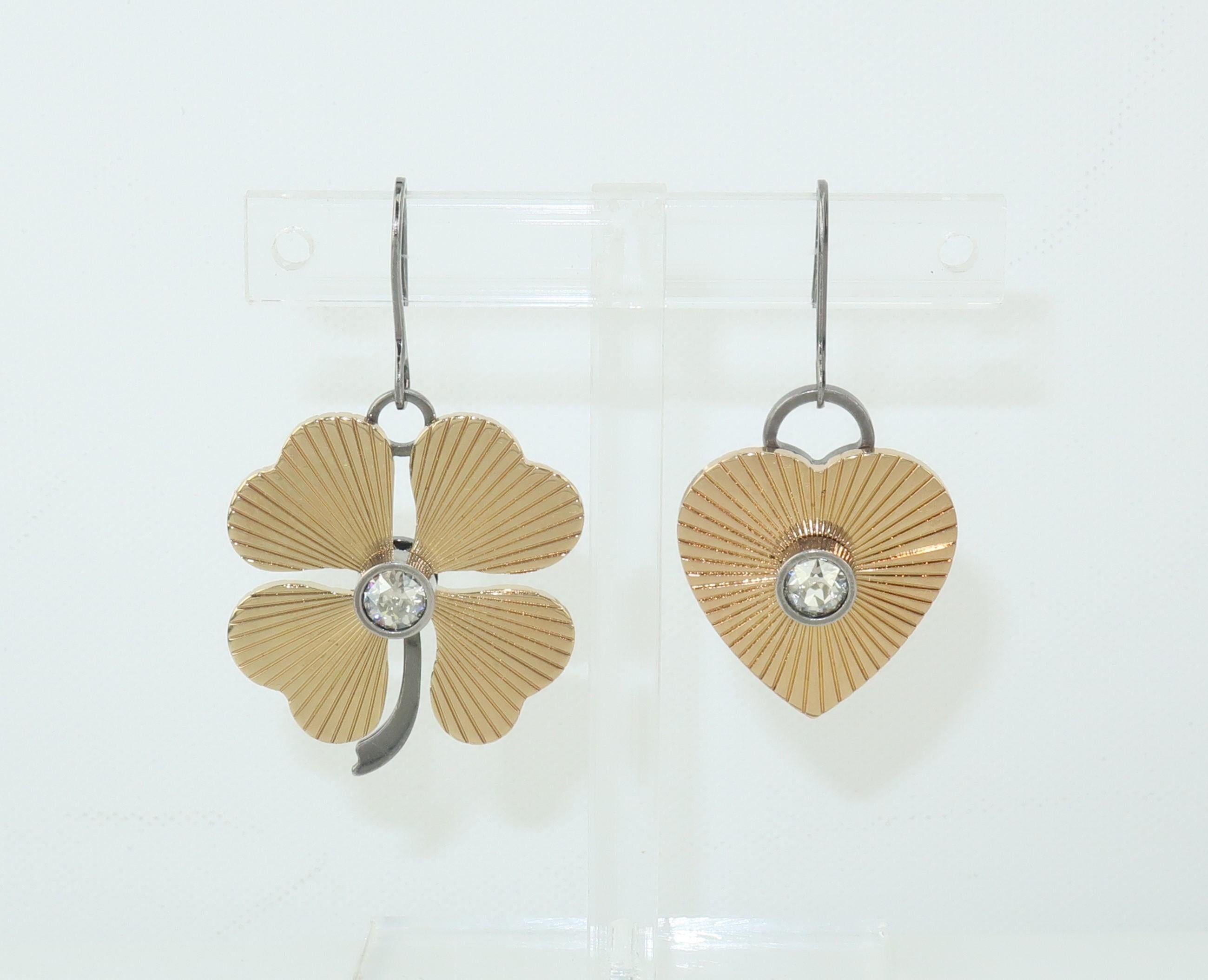 You will always be lucky in love with these mismatched Lanvin heart and clover motif earrings.  Designed in brass with some components in a ruthenium finish providing dimension and contrast.  They are accented by fluting to the brass surface and