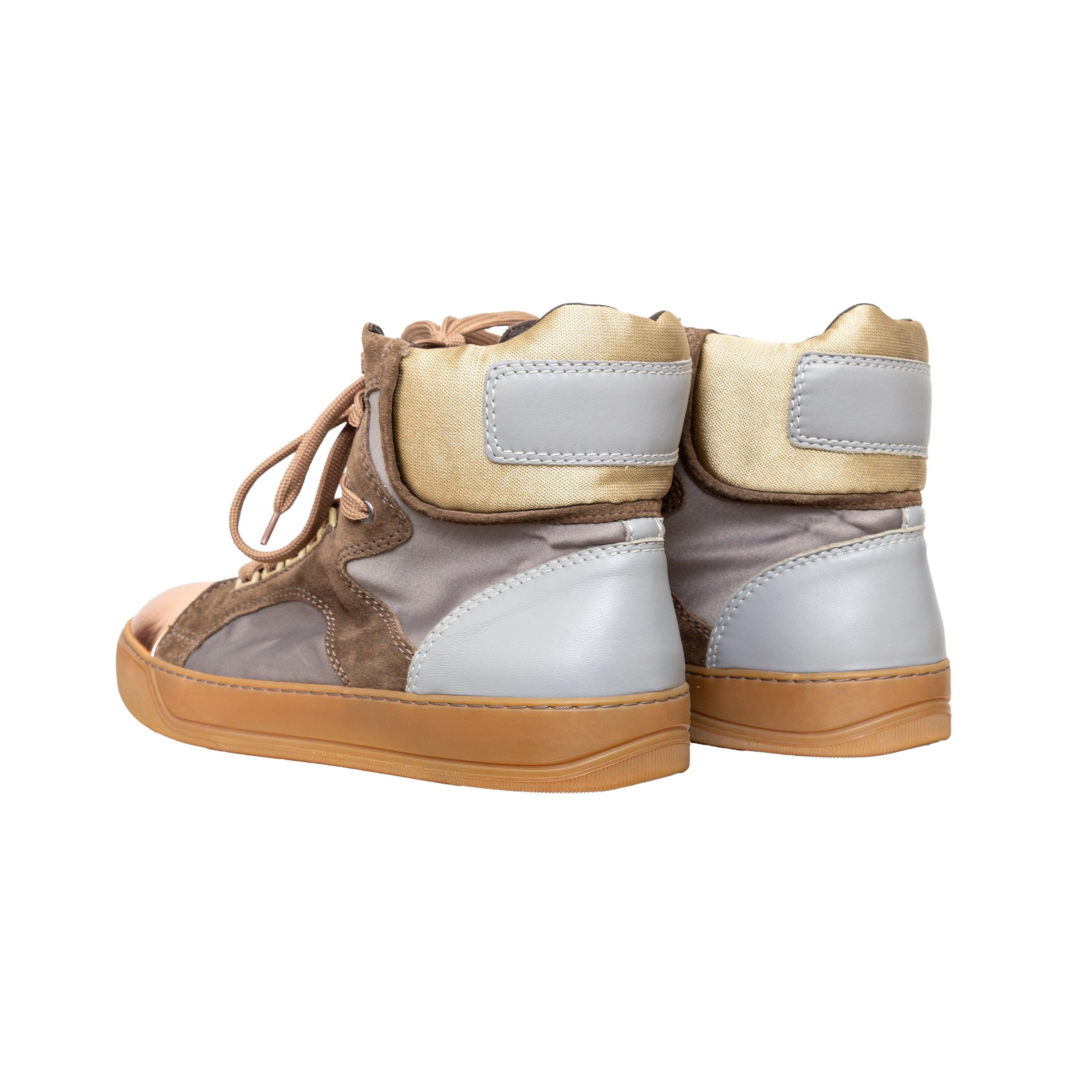 Metallic leather cap toe high top sneakers in neutral tones with rubber trim, round toes, and lace-up closure for a sleek look. 
 Measurement: Insole Length:28.5;Heel:3 
 Material: Suede  Leather  Fabric