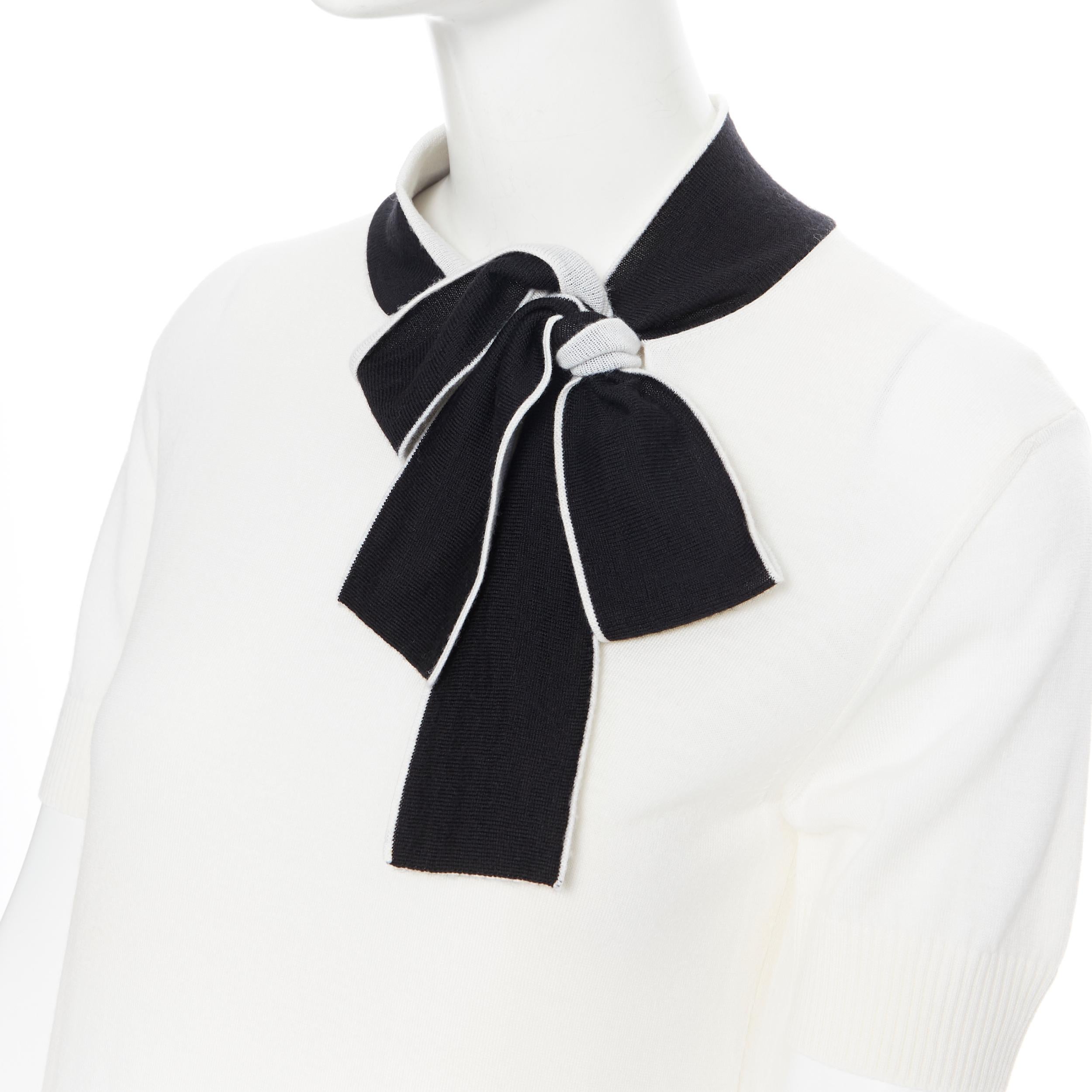 LANVIN ivory white wool black bow tie short sleeve sweater top XS
Brand: Lanvin
Designer: Alber Elbaz
Model Name / Style: Bow tie sweater
Material: Wool blend
Color: White
Pattern: Solid
Extra Detail: Self tie bow at neckline. Short sleeve.
Made in:
