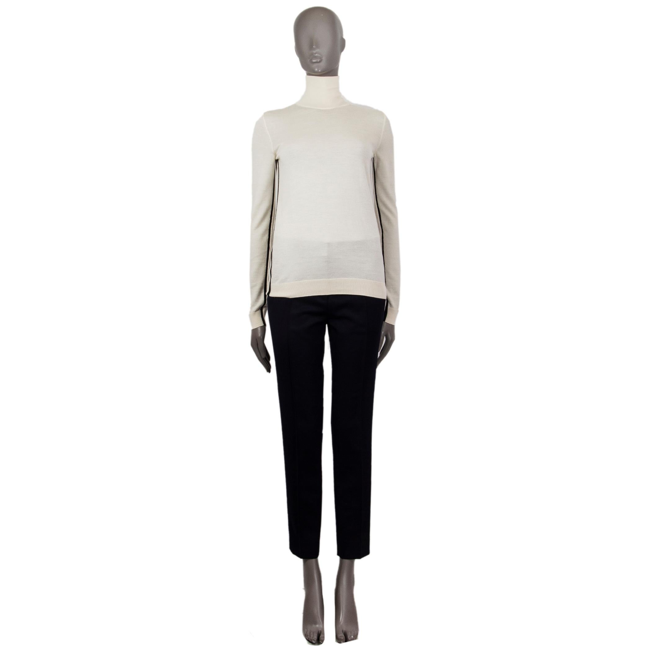 100% authentic Lanvin light turtleneck in ecru wool (65%) silk (18%) cashmere (9%) with a stand-up collar, detailed with knitted Lanvin logo diagonal along the left side. Has ribbed cuffs and hem. Has been worn and is in excellent