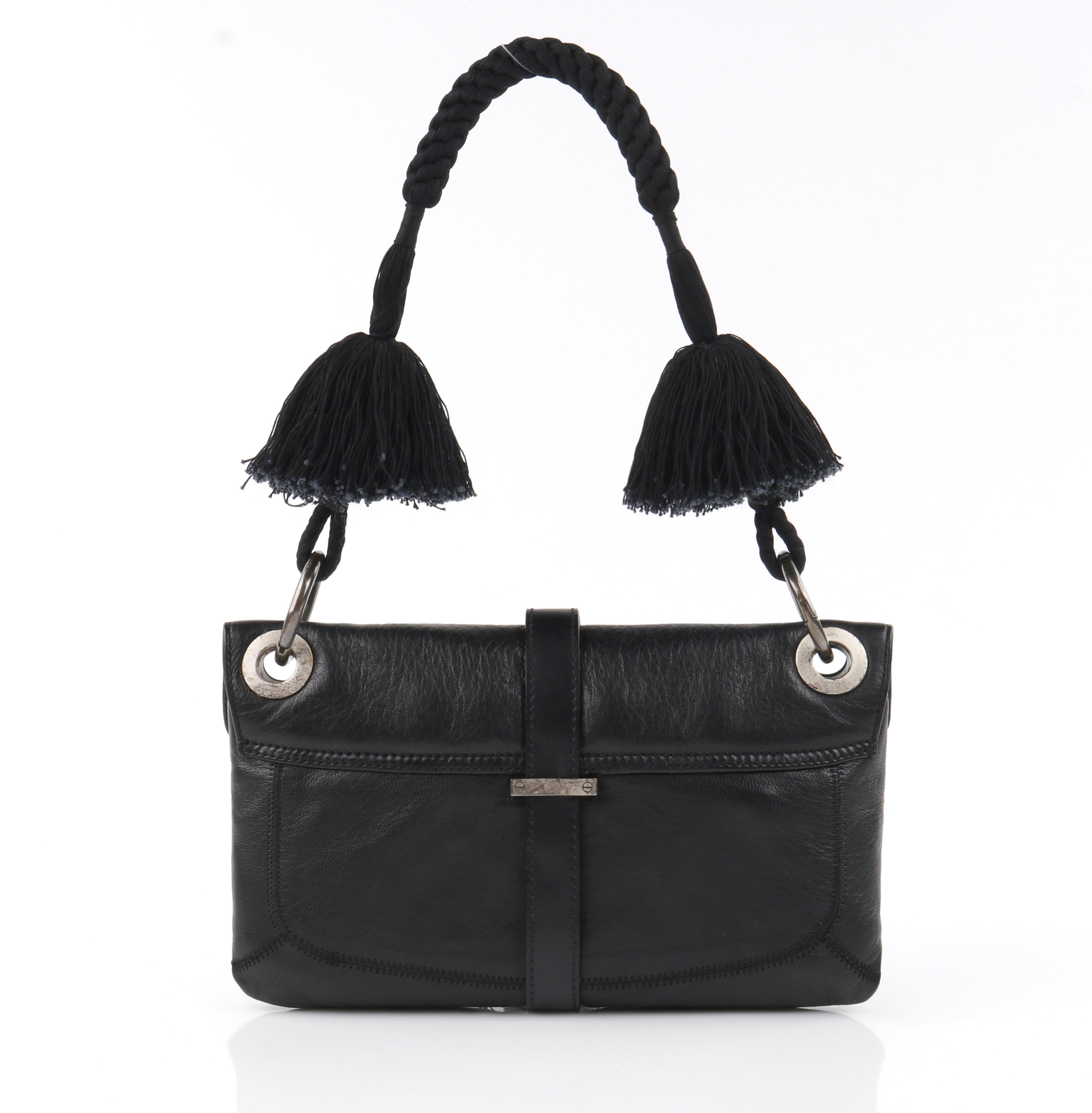 LANVIN “Jeanne” Black Leather Braided Pom Pom Tassel Strap Flap Clutch Handbag 

Brand/Manufacturer: Lanvin Paris
Style: Handbag with flap; toggle closure
Color(s): Black (fabric); silver (metal hardware)
Lined: Yes
Unmarked Fabric Content (feel