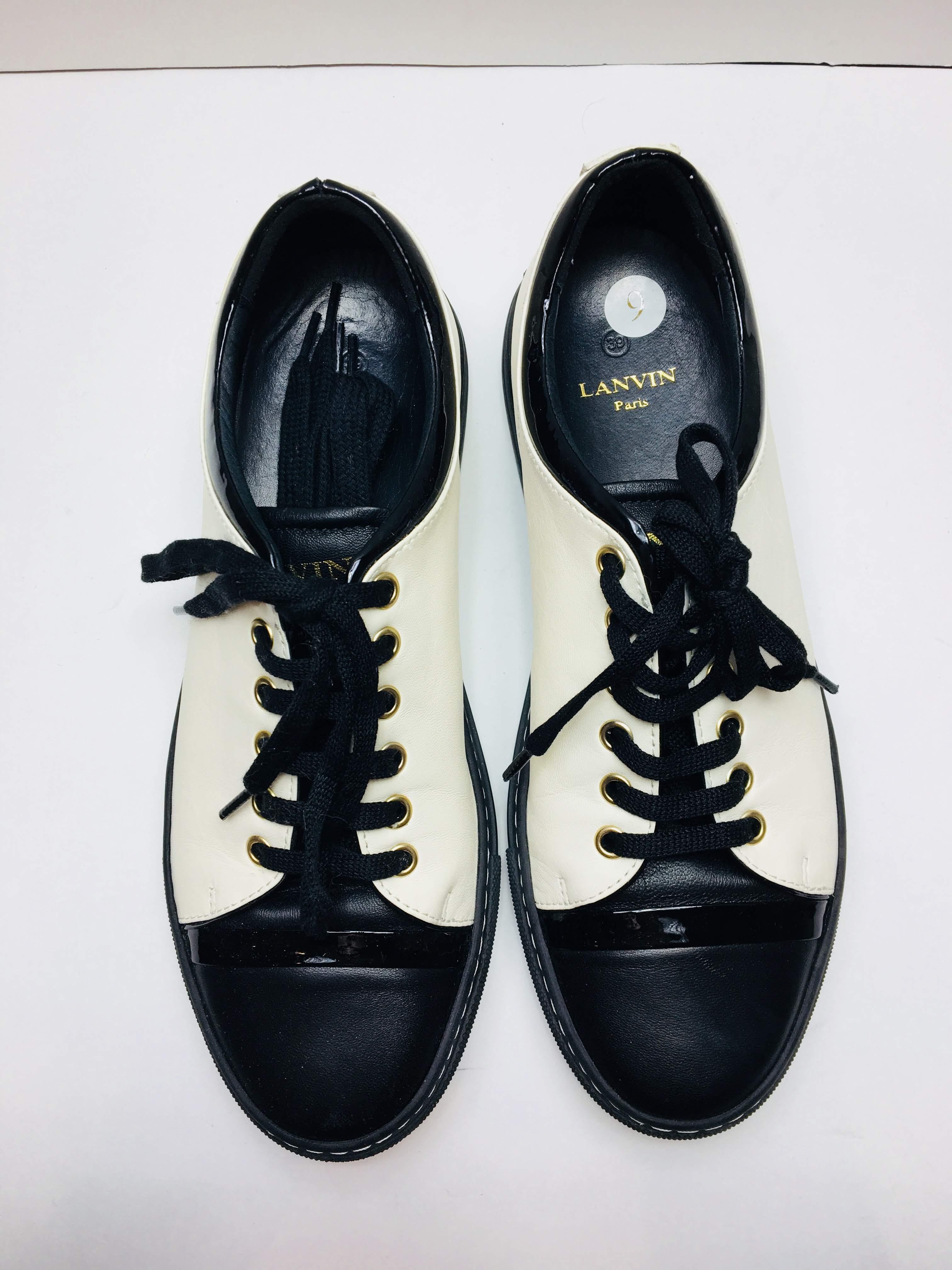Lanvin Paris  puts an elegant spin on the classic sneaker with this low-top pair ofBlack/Creme Leather with Creme stitching on edges. 
Slightly Worn.
Size 39
 Made in France 
upper: lamb leather, calf leather
lining: leather
sole: leather insole,