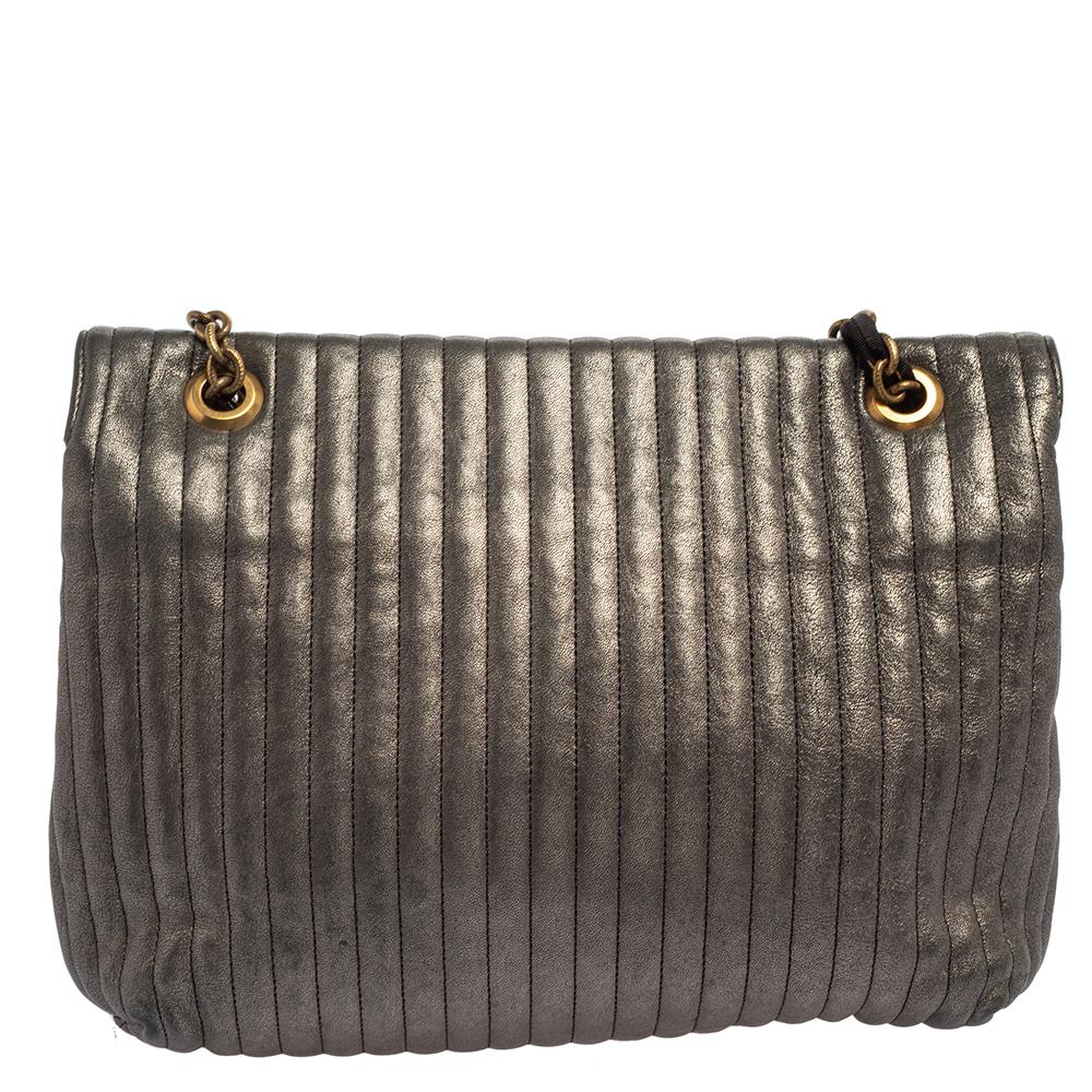 Lanvin brings you this super-stylish shoulder bag that carries a design that will surely delight your tastes. It comes crafted from quilted leather in metallic grey and styled with a turn lock on the flap, a shoulder handle, and a well-sized fabric