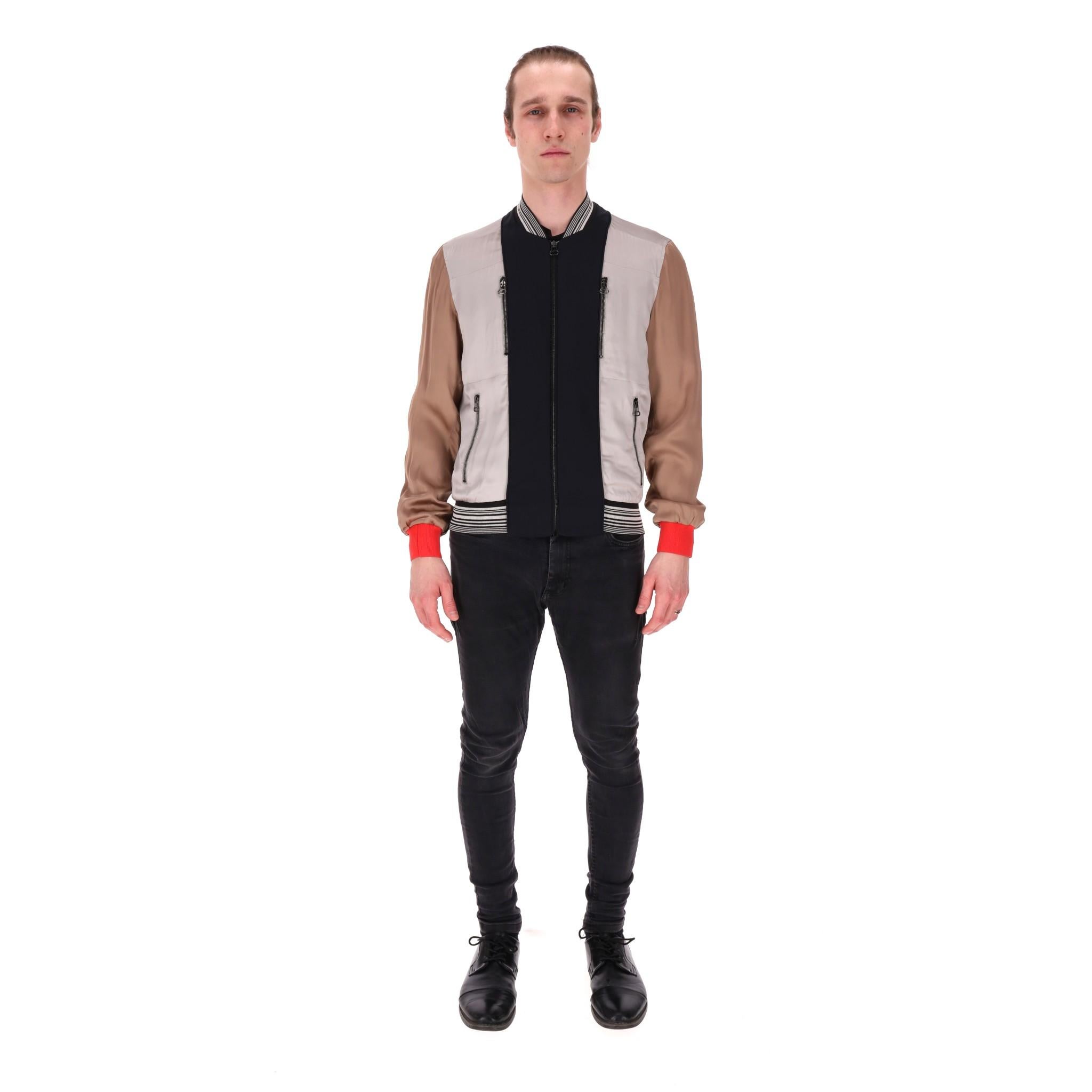 Lanvin Metallic Satin Panelled Bomber Jacket

Multicoloured bomber jacket with metallic grey bodice detailed with navy panel to the centre.

Featuring metallic beige sleeves with red cuffs. Centre zip fastening and four zipped pockets to the