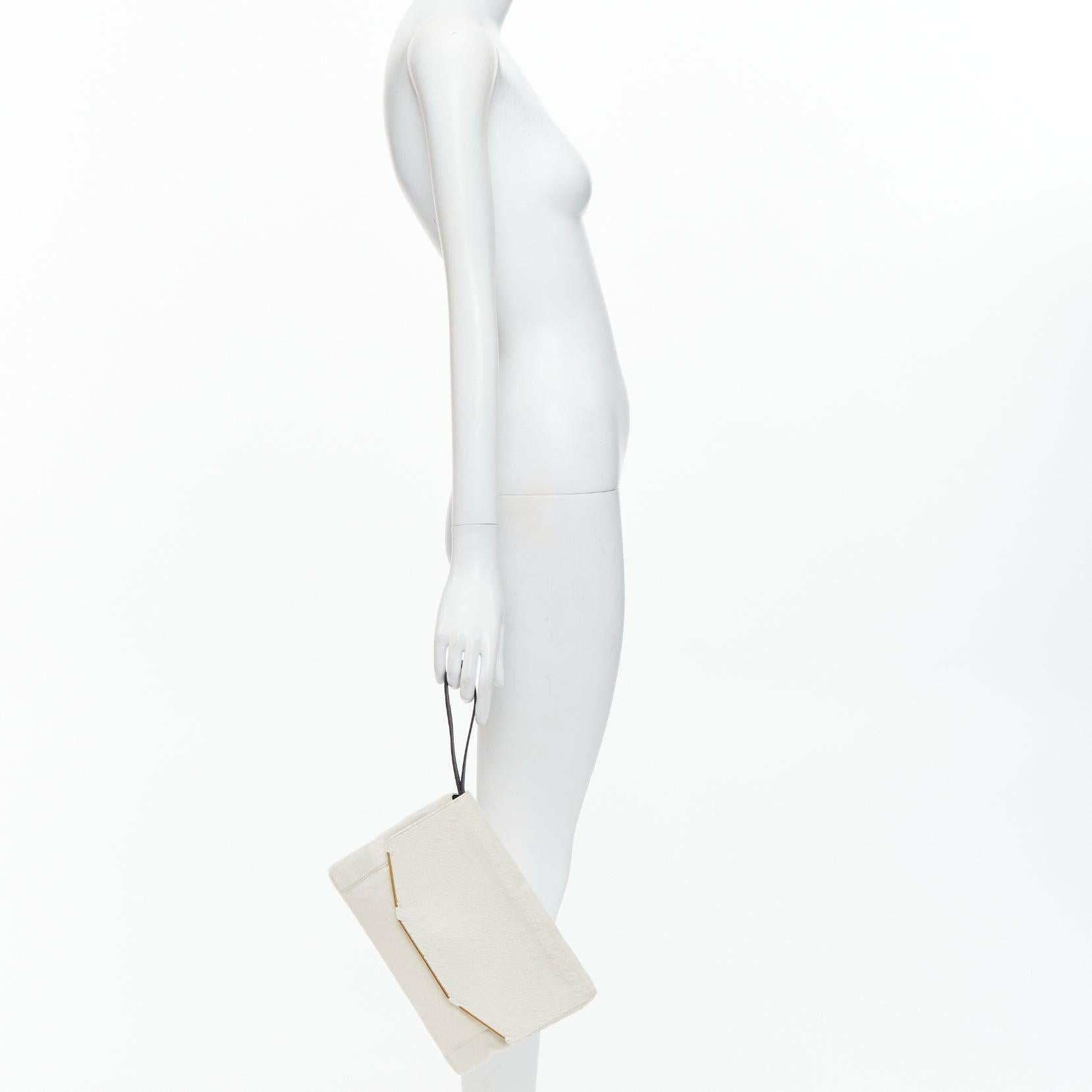 LANVIN Miss Sartorial off white calf hair gold bar flap envelope clutch bag
Reference: NKLL/A00489
Brand: Lanvin
Designer: Alber Elbaz
Model: Miss Sartorial
Material: Calf Hair
Color: Cream, Gold
Pattern: Solid
Closure: Magnet
Lining: Grey