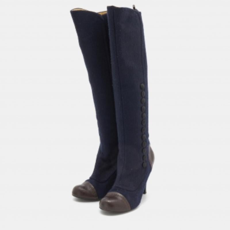 These knee-length boots from Lanvin are stunning. Crafted in Italy, they are made of fabric and leather. With navy blue and brown hues, they are versatile and exude effortless style. They are equipped with 9.5 cm heels, leather insoles, and tough