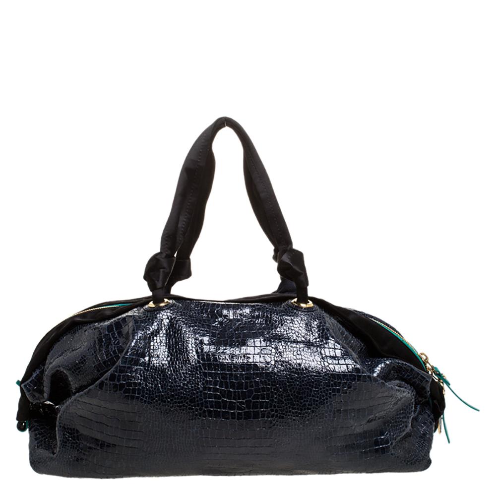 Creations as lovely as this Duffle bag by Lanvin never go out of style. This navy blue bag is crafted from croc-embossed leather and it features dual handles and gold-tone hardware. The top zipper opens to a nylon interior sized to carry your