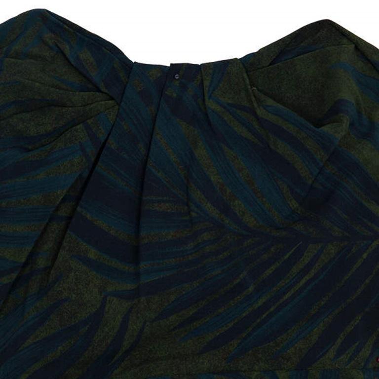 This exquisite dress is printed in a deep green and blue tropical leaf print. It has gathered detailing on the chest and ruched detailing to one side. It comes with an exposed side zipper closure. Original Retail Price: $3,025