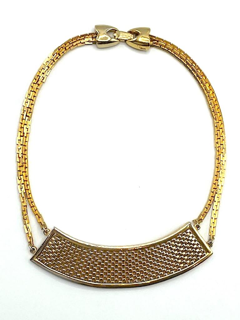 A charming and classic Lanvin necklace with woven bib front from the 1980s. The solid curved front is comprised of a basket weave piece of flat wire that is inset into a solid back plate. It measures 3.5 inches wide and 1.13 inches high. Two strands