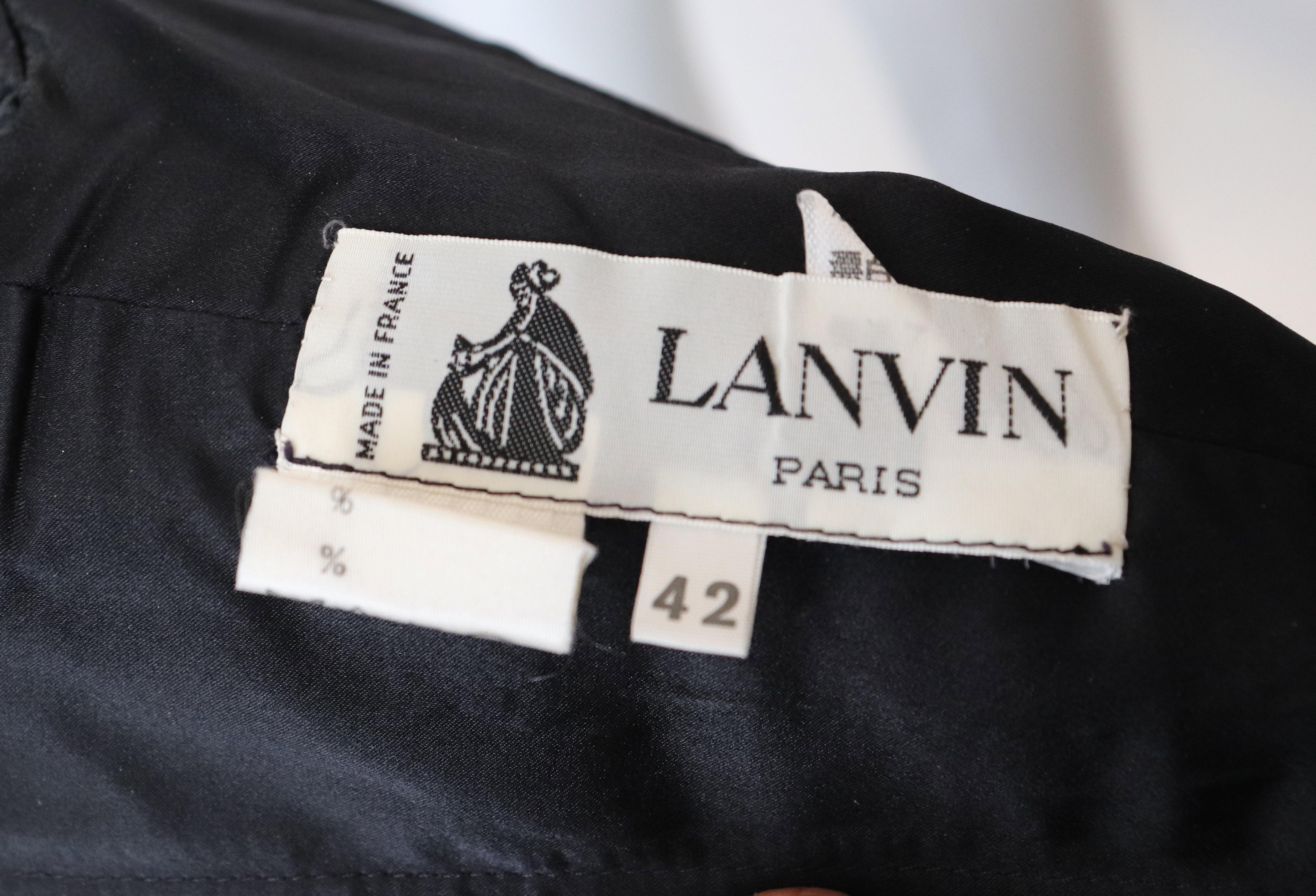 A chic black velet dress by Lanvin Paris. The dress should be worn off the shoulder with the ribbon ties on the shoulder. It is fully lined, with a central back zip, and has internal waist ties.